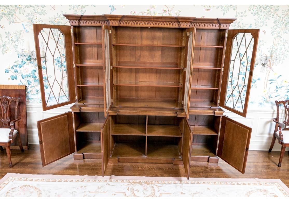 A large and beautifully crafted Breakfront with striking inset Burl doors and a particularly strong presentation featuring carved Columns. Pair of mahogany Burl doors have fine wood fretwork framing and are flanked by two further drawers. Above are