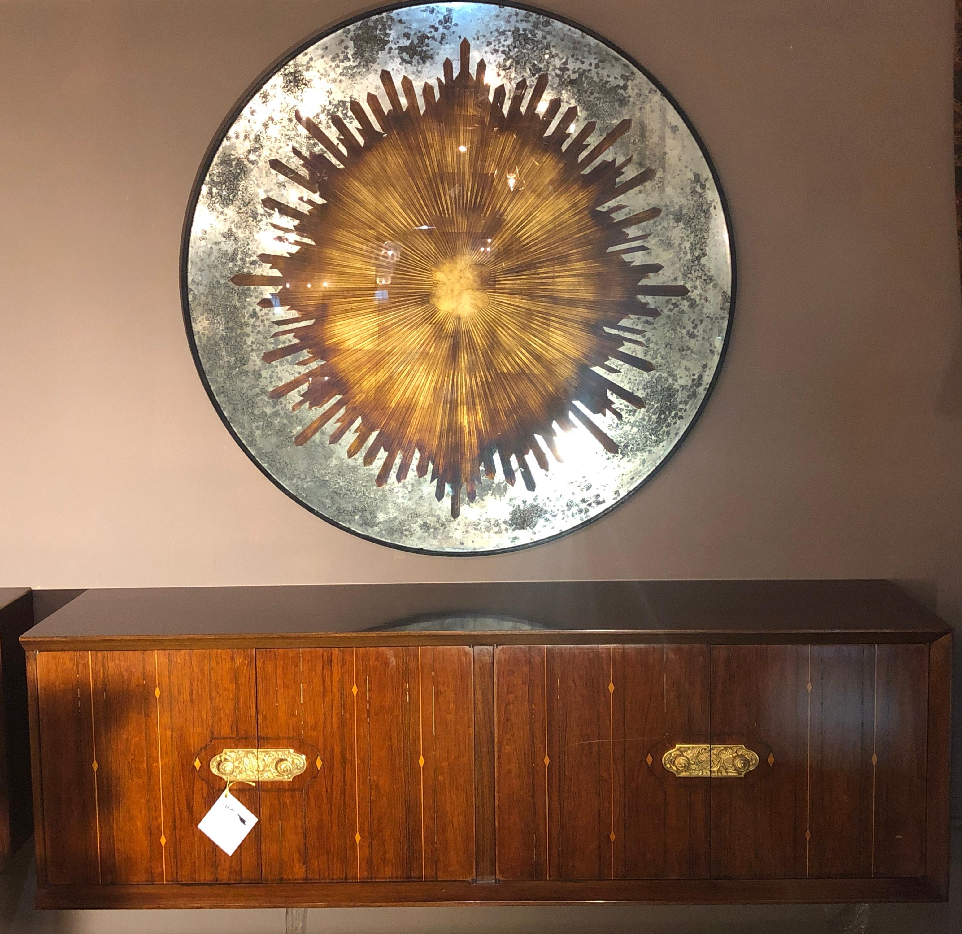 Monumental carved gilt gold and silver glass Art Deco sunburst wall mirror or tabletop. This spectacular finely decorative mirror would make a splash whether hanging on the wall or sitting upon a metal table base. Can easily be used as a centre or