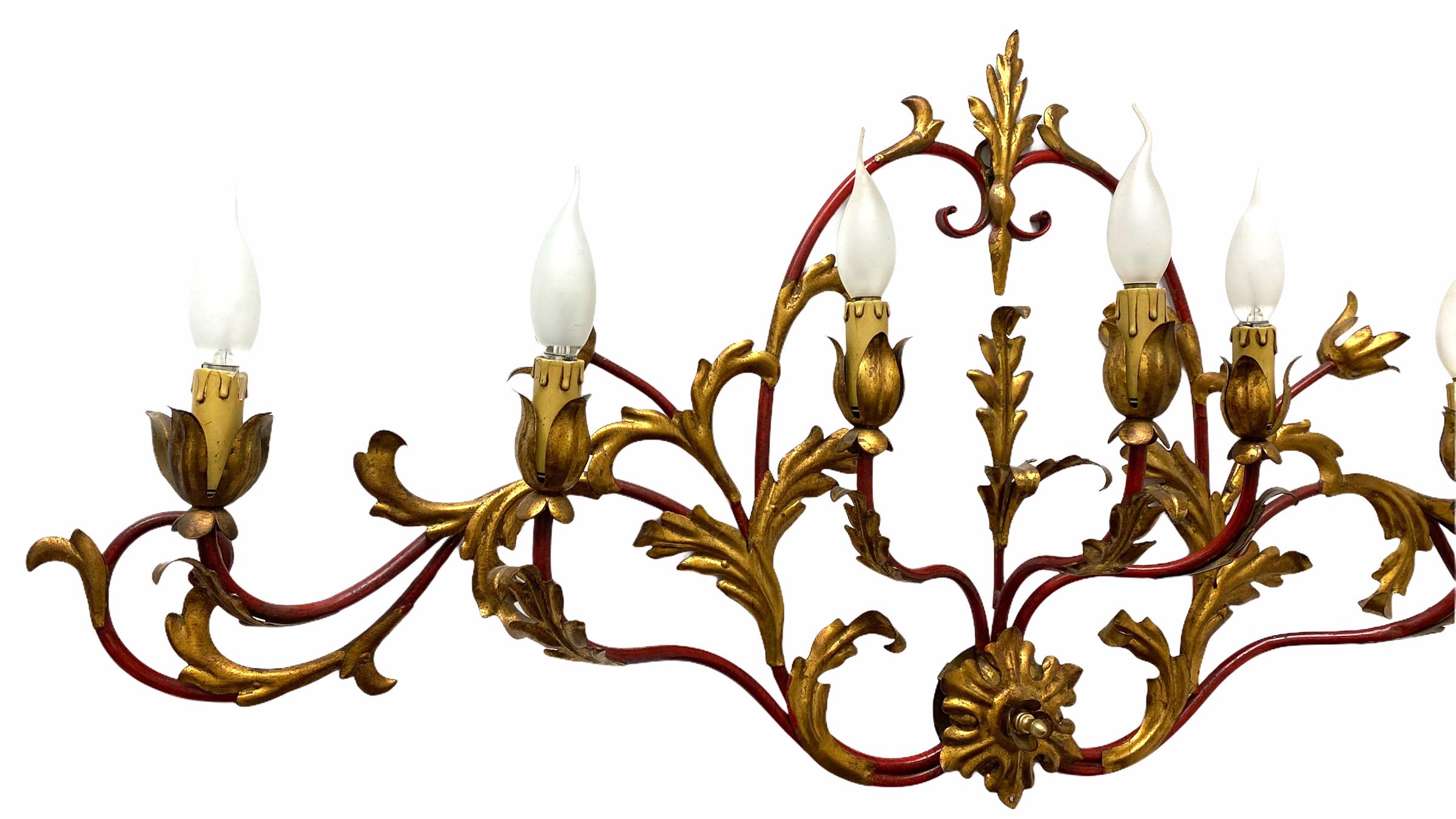 Add a touch of opulence to your home with this charming monumental sconce. Perfect gilt metal leafs on red rods, to enhance any chic or eclectic home. We'd love to see it hanging in an entryway as a charming welcome home. Built in the 1960s,