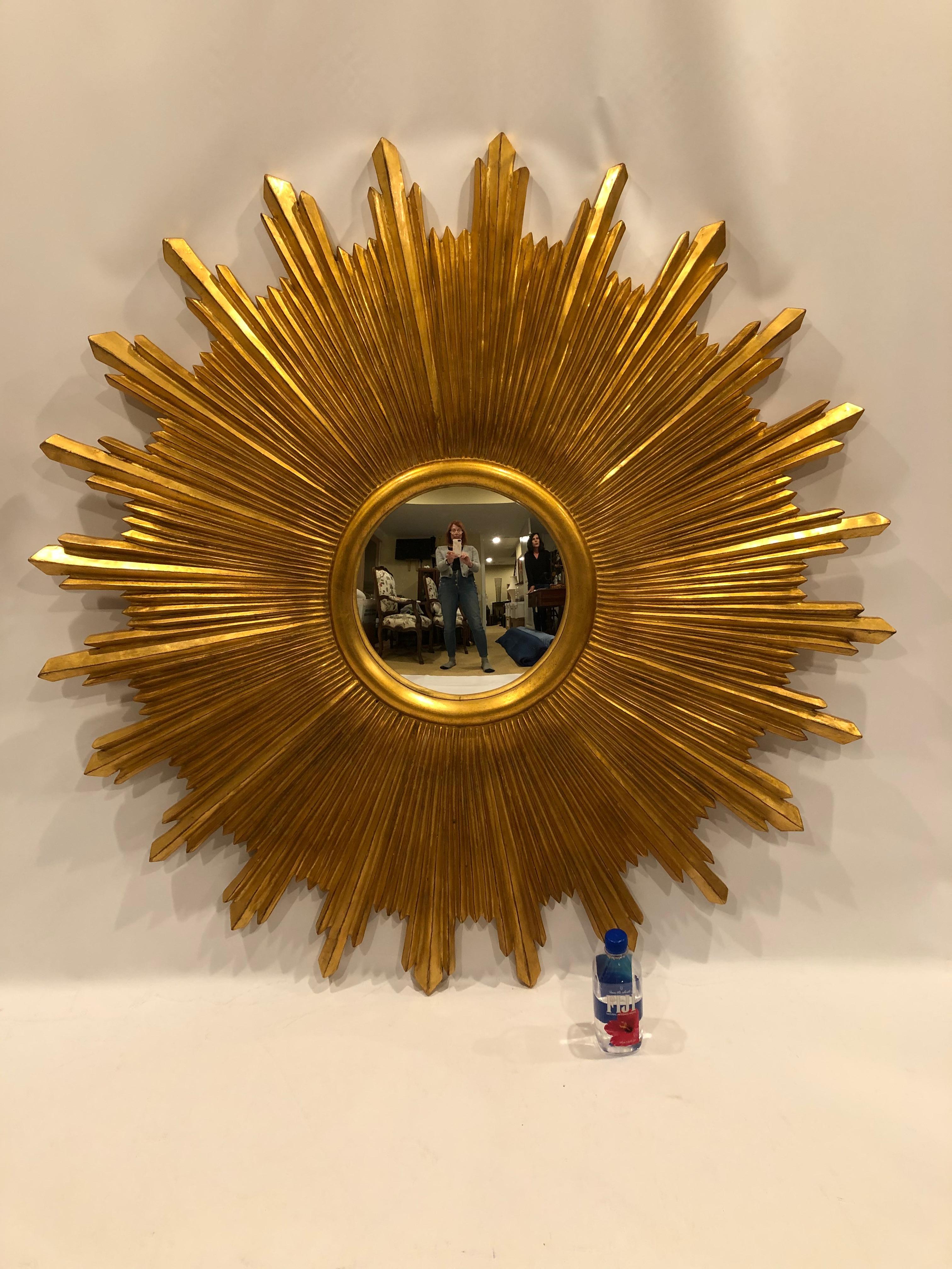 Super huge and movie star glamorous sunburst mirror having eye popping gilded rays beautifully crafted by Carvers Guild with 12