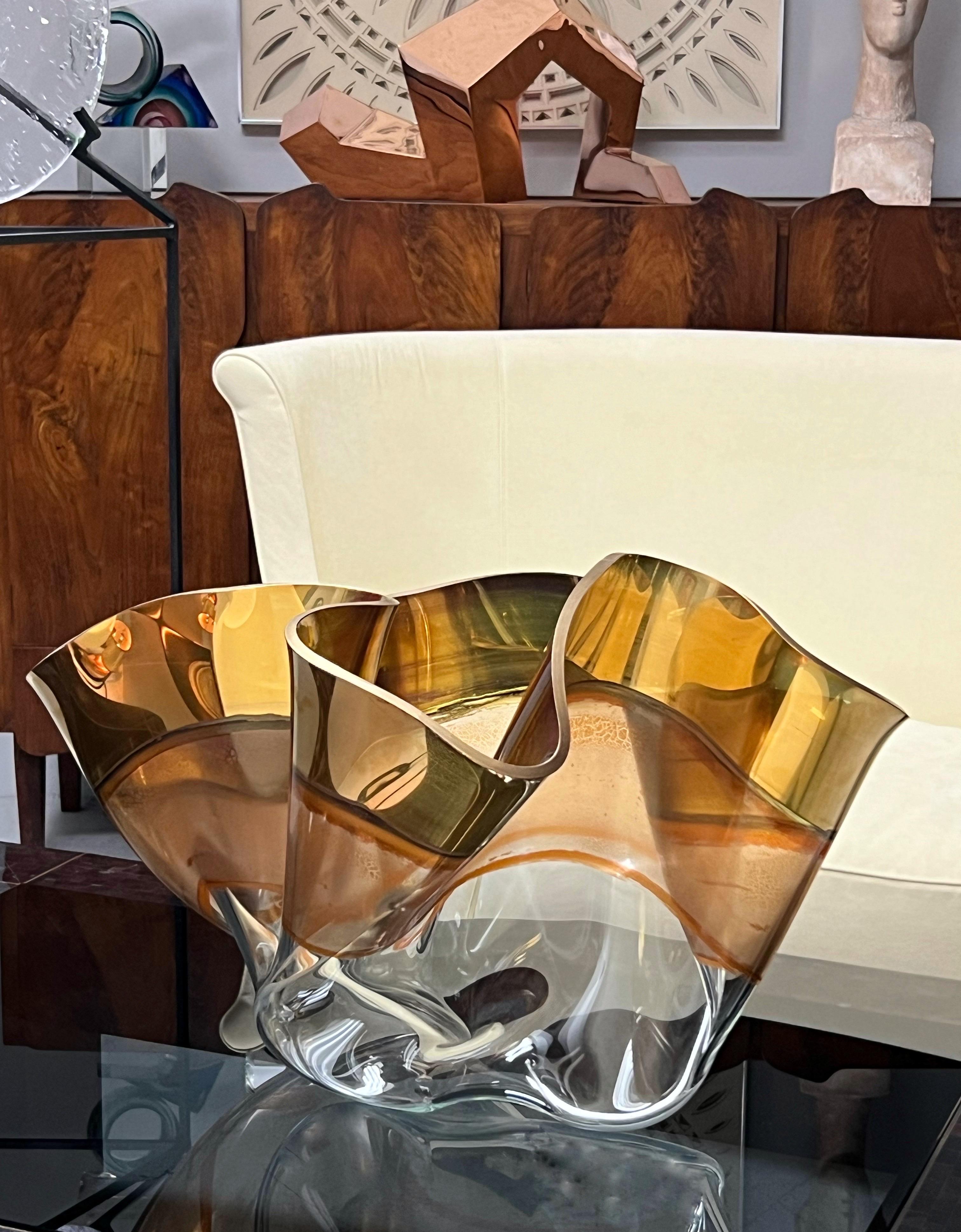 A very large sculptural piece of art glass by Laurel Fyfe (1956-2011)
A “Marina” vessel, slumped glass with color and metallic luster application. In this case gold metallic with copper undertones. Could be presented on its side as well
