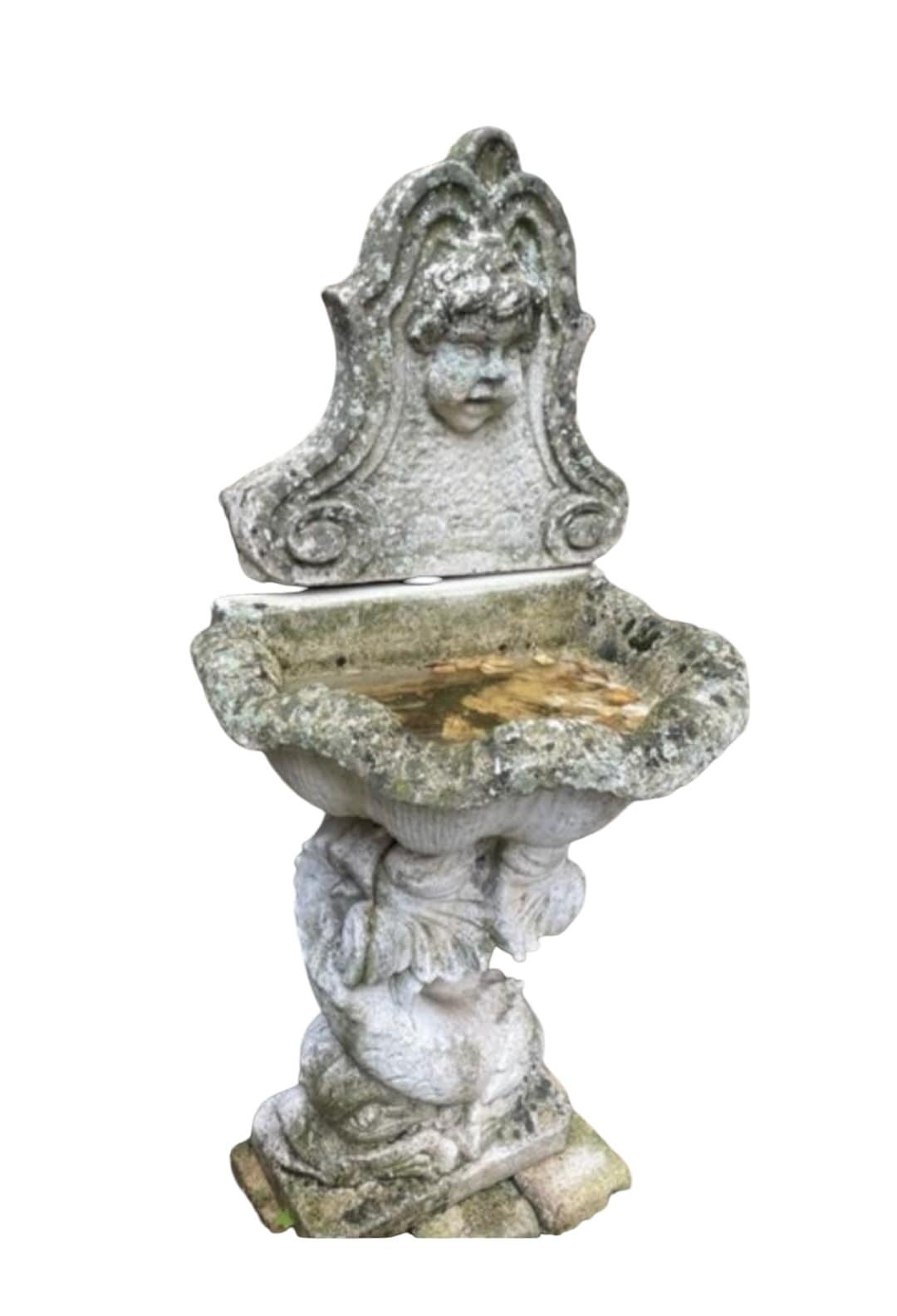 Introducing an extraordinary Monumental Greek-Style Fountain in Reconstituted Stone from the mid-20th century. This magnificent piece is richly adorned with intricate sculptures and features a striking lion head spout, making it a captivating