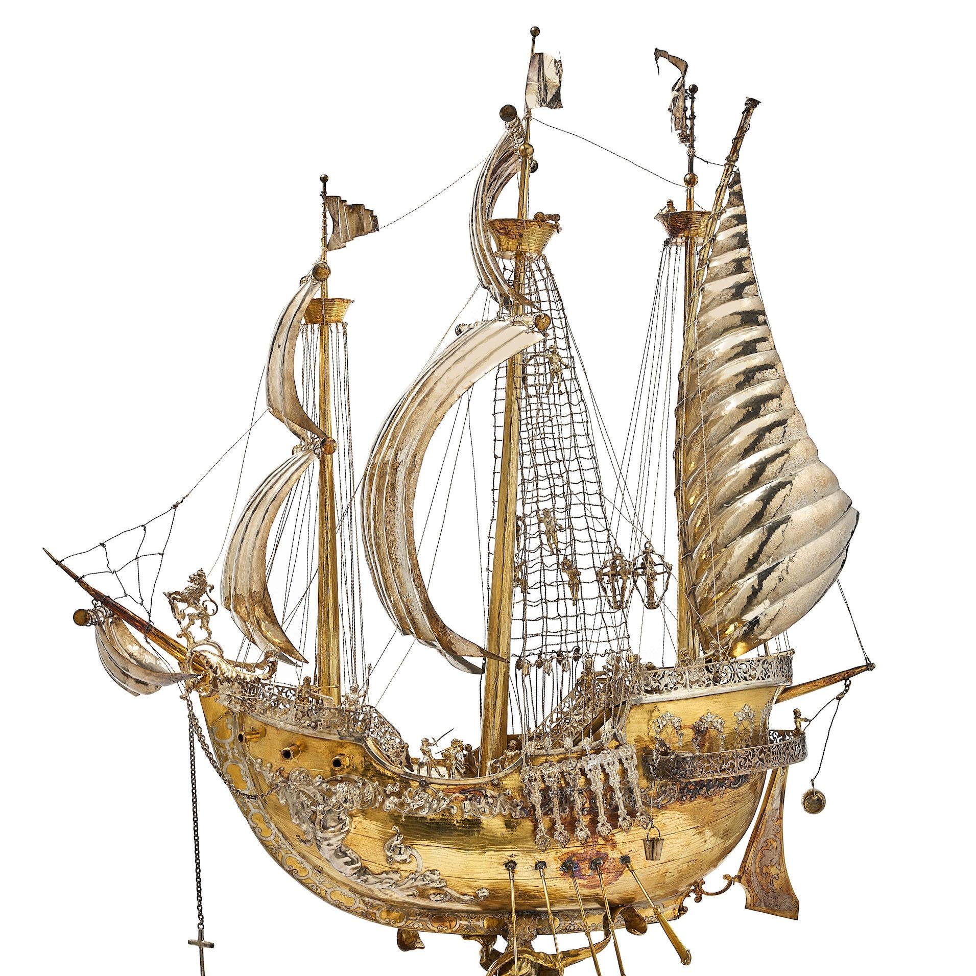 Our monumental silver gilt Schlüsselfelder ship or nef, attributed to Hanau, Germany, late 19th to early 20th century, measures an impressive 45 1/4 inches (115 cm) tall and is exquisitely modeled in the 17th century style as a galleon at sail  with