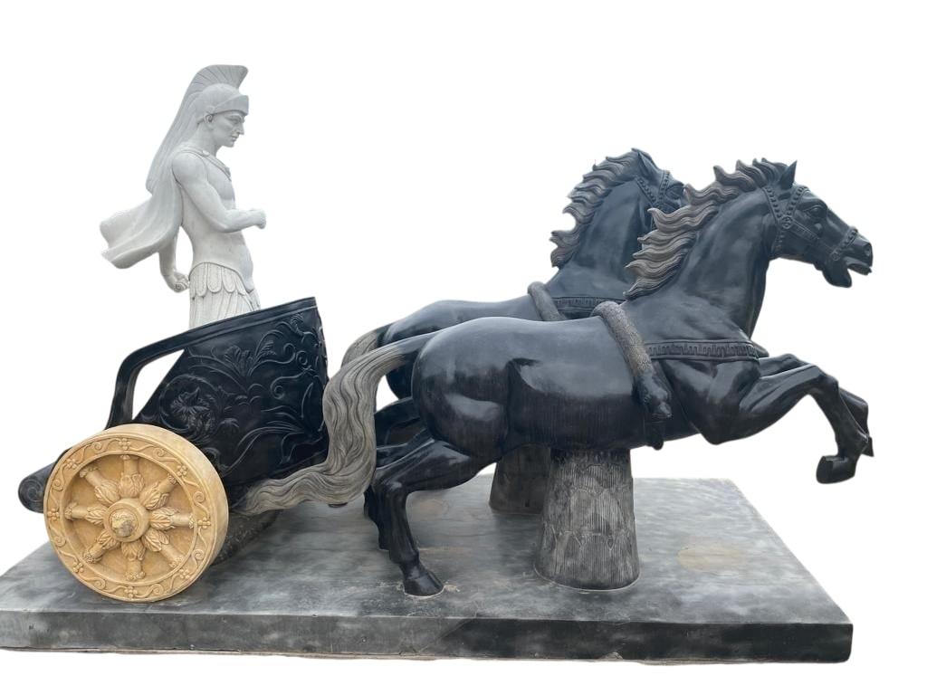 Striking and rare monumental marble sculpture depicting a Roman chariot (quadriga), entirely hand-carved in Italy from contrasting white and black marble. The dynamic scene features a Roman centurion standing in a classical chariot drawn by two