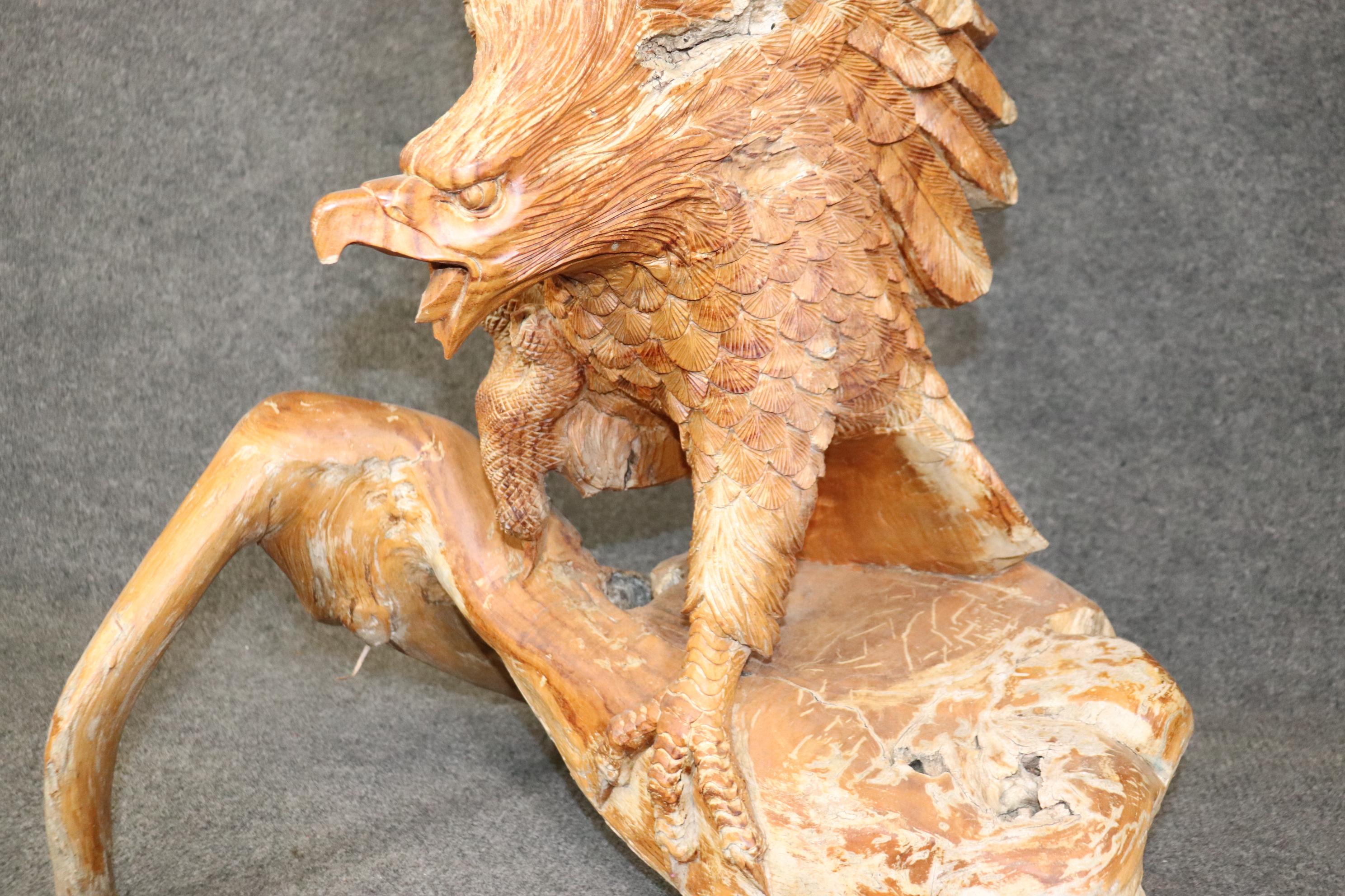 Il s'agit d'une seule pièce de bois, sculptée à la main de façon experte et incroyablement détaillée, avec des plumes, des serres, un bec et des ailes de style naturaliste. L'aigle à tête blanche vient d'atterrir et semble être un oiseau vivant en