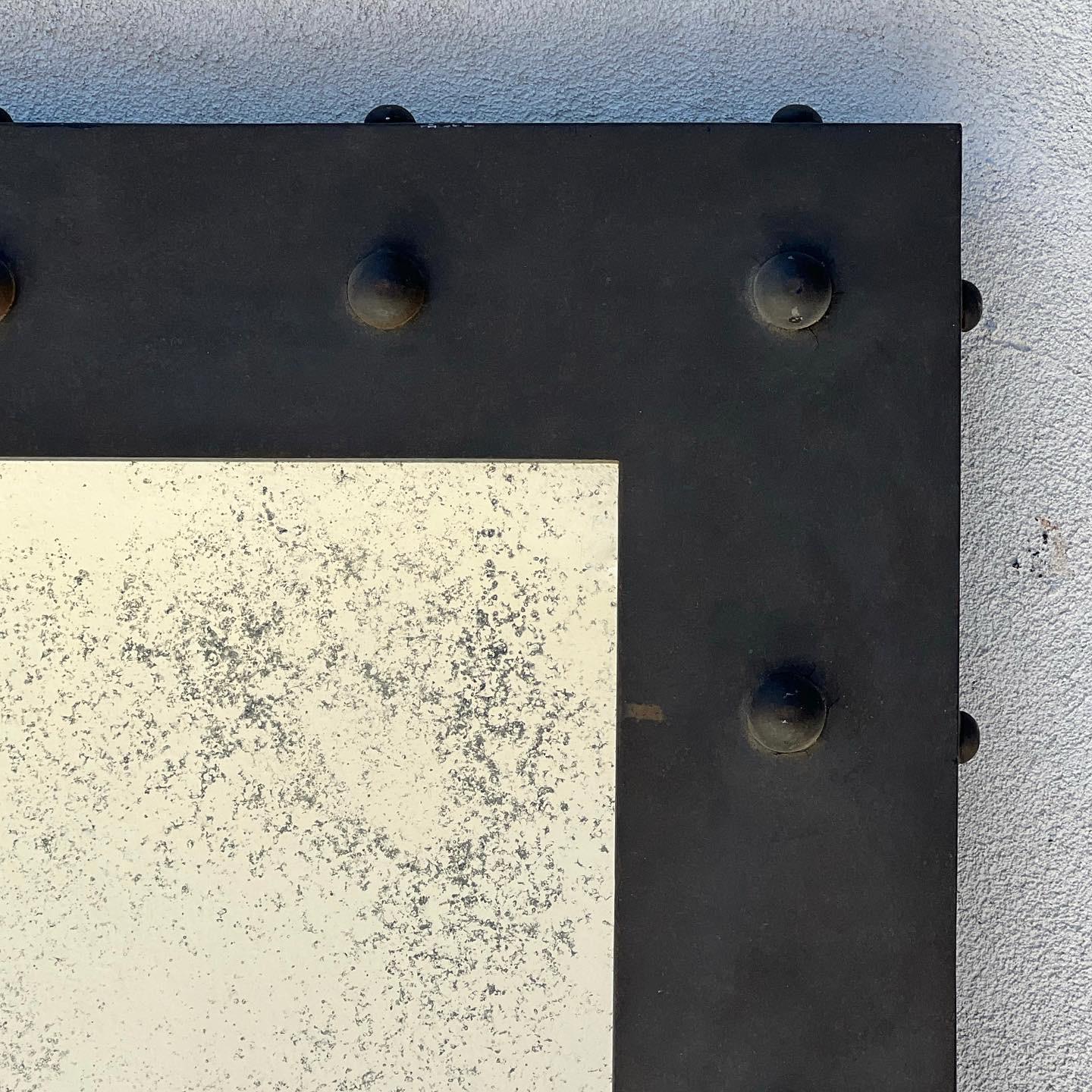 A custom monumental hand-forged iron mirror with industrial and brutalist attributes by designer Michael Smith. Giant - and heavy. Fully unique; this piece was made specially for a member of the Belushi family and comes from his estate. Note the