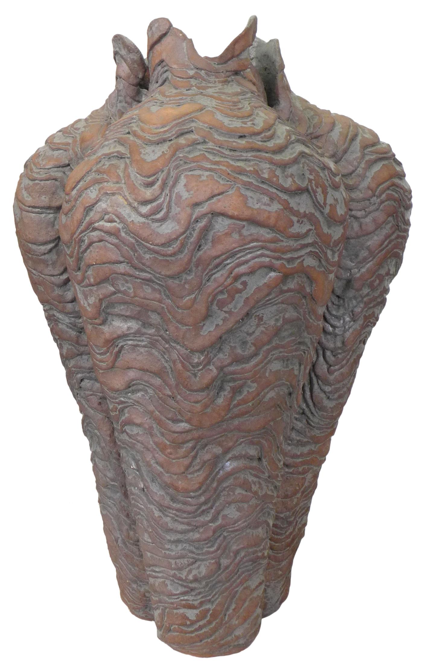 A monumental coil-built ceramic vase or vessel. A phyllomorphic, pod-like form with an undulating, approaching topographical, surface with a patinated bronze-like glaze. A sculptural, exceptional form skillfully executed. An outstanding example of
