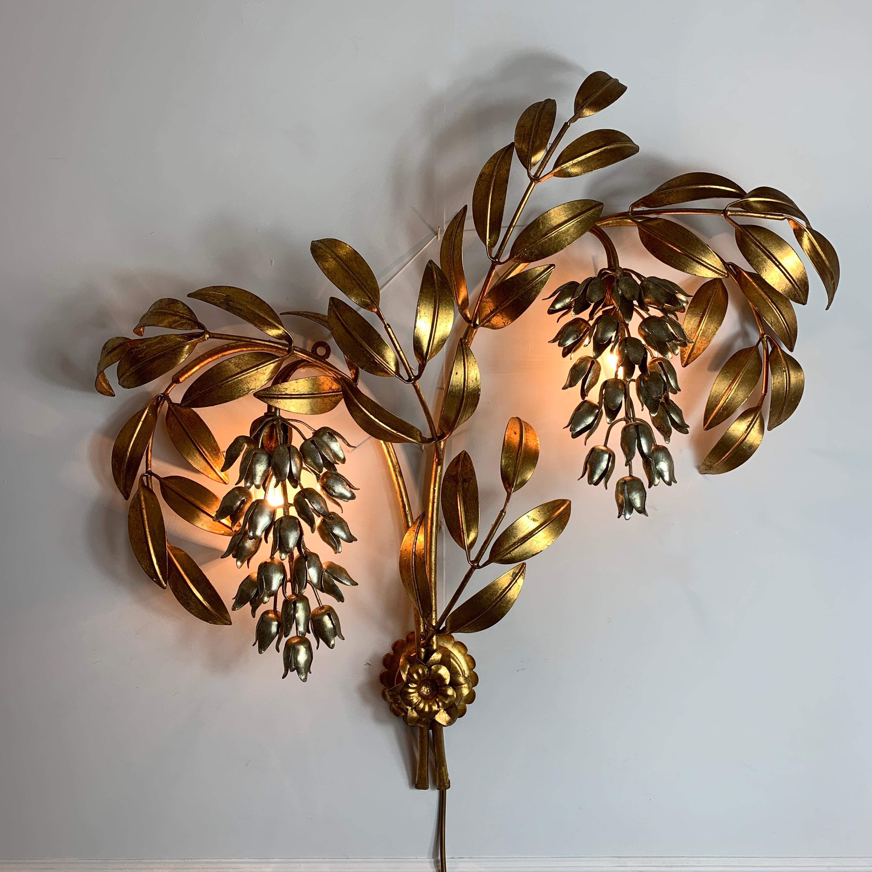 Monumental Hans Kögl Pioggia D'oro wall sconce
Large gold-plated leaved branches with hanging silver wisteria flowers
By the designer Hans Kögl

The sconce takes 2 single E14 bulbs, hidden behind each of the silver flowers
circa 1970s
Measures: 78cm