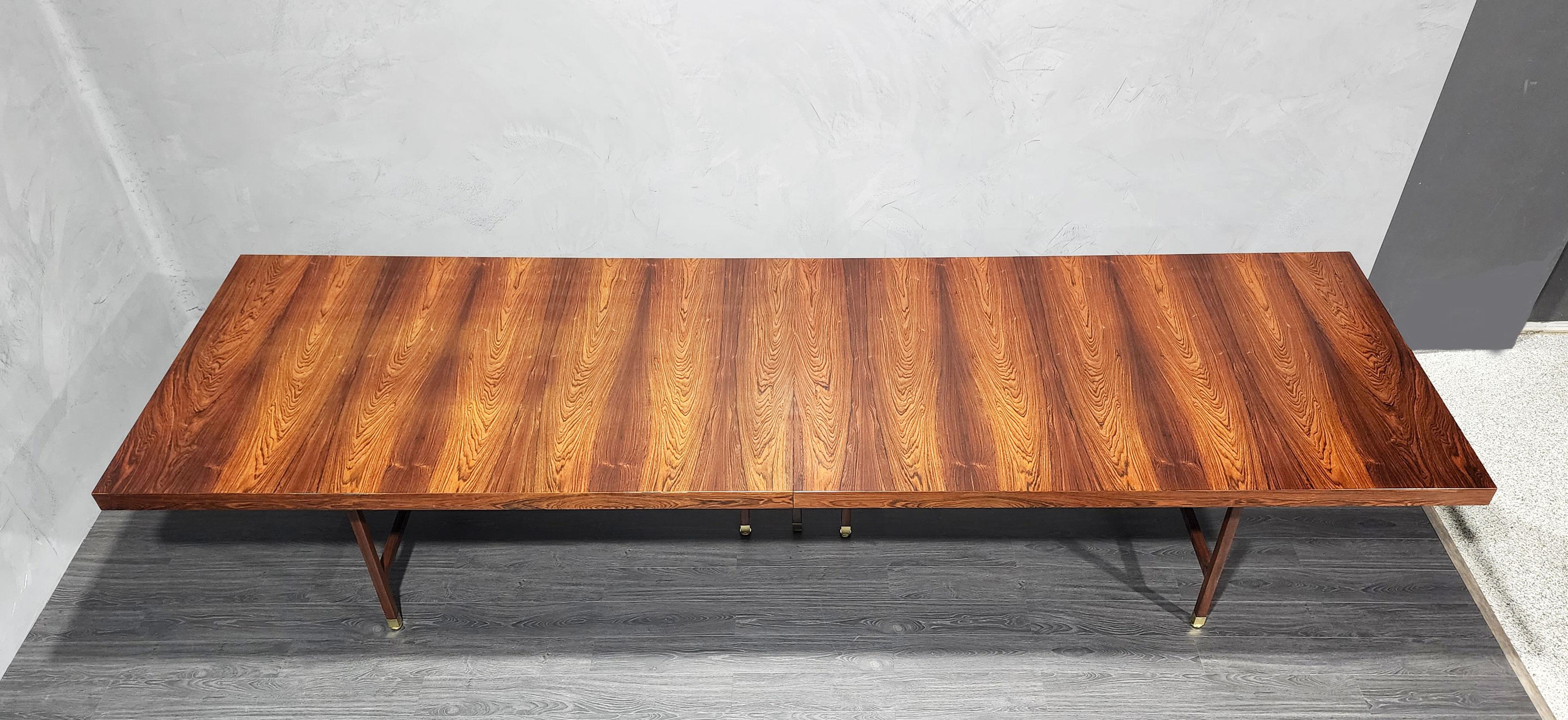 We are sure this was a custom order as they just did not make this table in the size unless specified. It is beautiful dramatic Brazilian rosewood. We have fully restored. Brass caps on legs and mahogany legs. There is one leaf with a support leg.