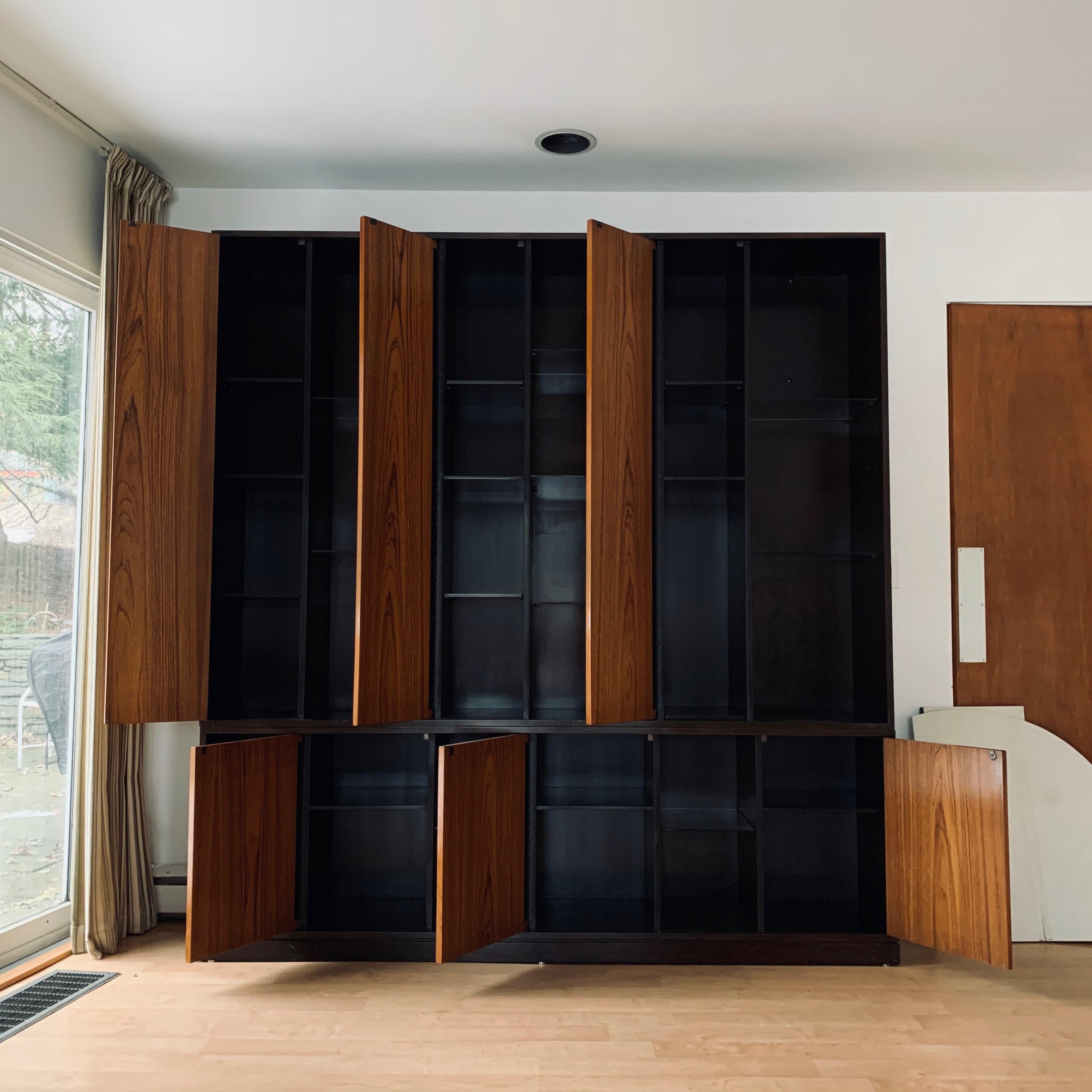 Impressive 1960s Harvey Probber wall unit/cabinet with 6 doors and wooden shelves. Exposed shelves are glass for displays. The cabinet is a dark stained mahogany and the doors are a light walnut. Plenty of storage and display options in a beautiful