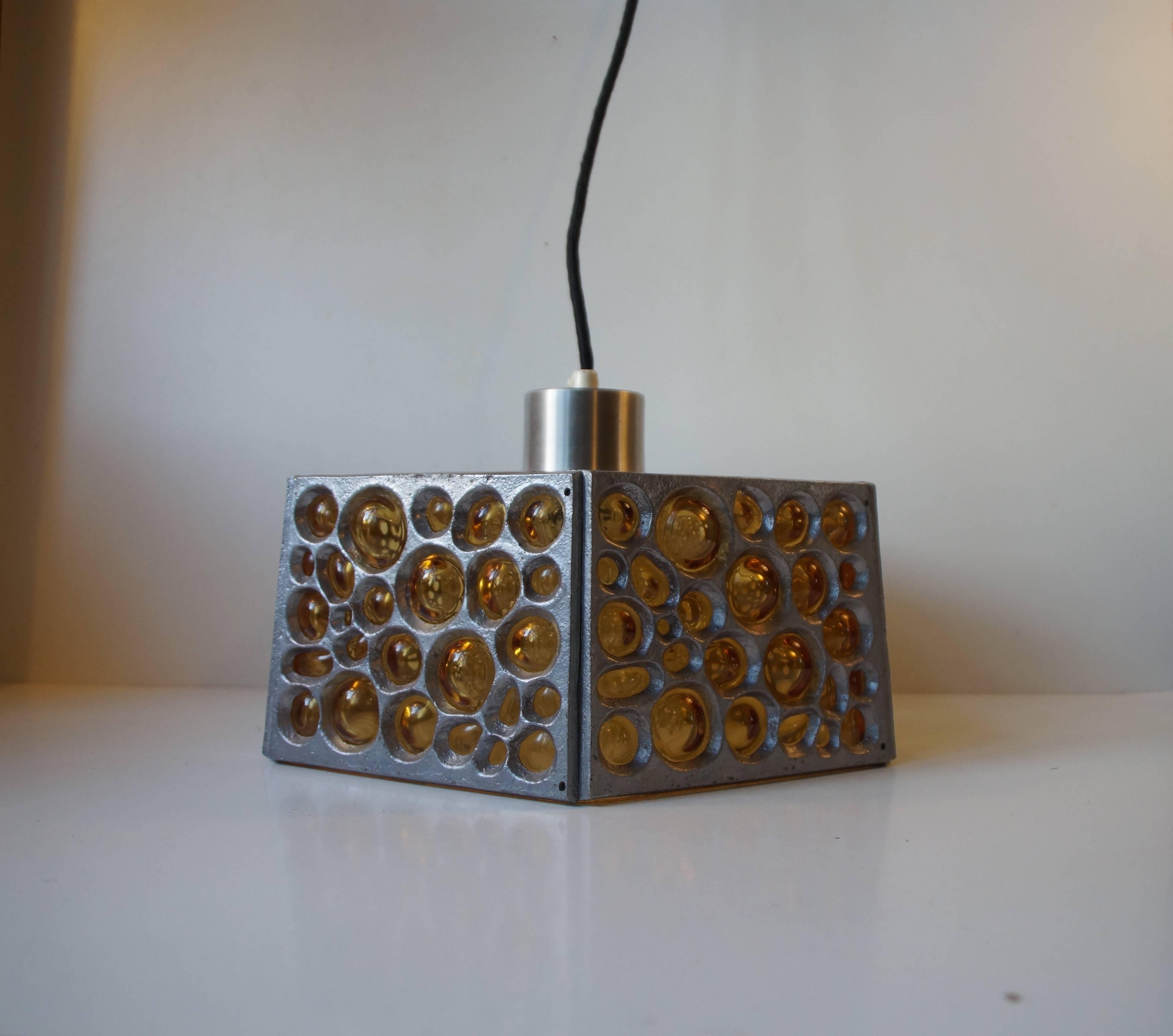 Pendant chandelier with pertruding bubbles that resembles the surface of the Moon. Caged in textured steel panels the bubble glass peeks out via the craters. The hexagonal shape is echoed by the patterns of the clear inner-shade.
Beautiful intact