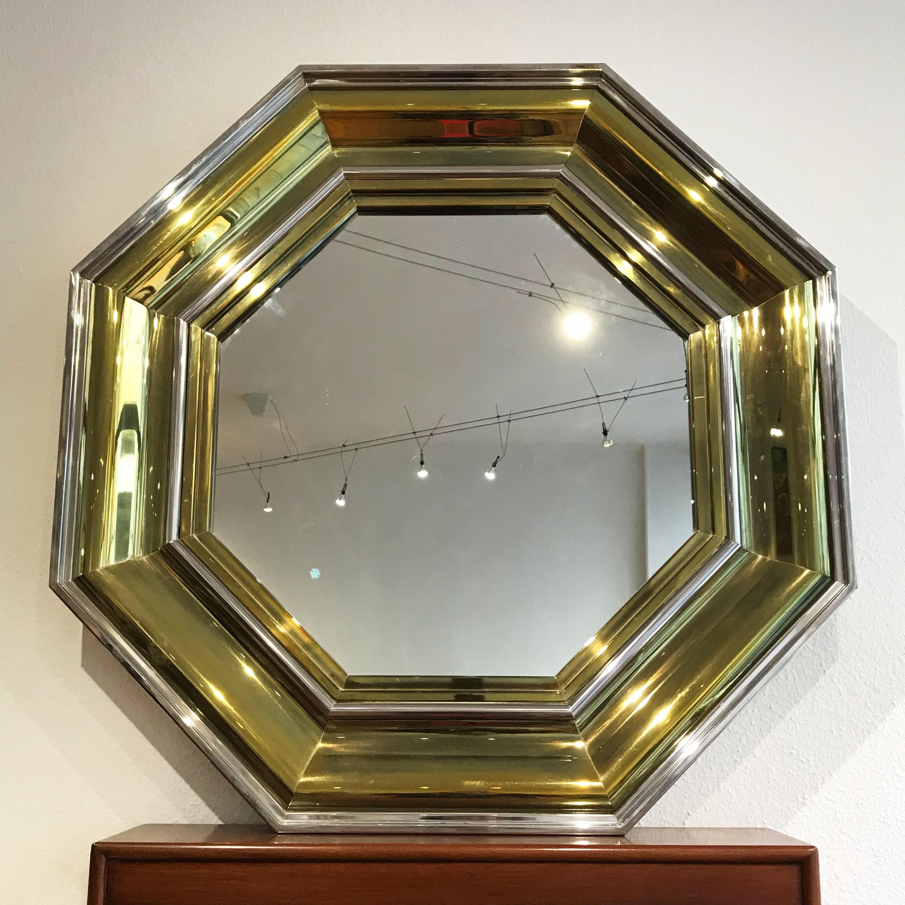 Monumental Hollywood Regency style octagonal bicolor wall mirror. Designed by Sandro Petti in 1970s, Italy (signed). Manufactured by Maison Jansen, France. Executed in brass sheet and mirrored glass.

Nearly excellent vintage condition. Wear