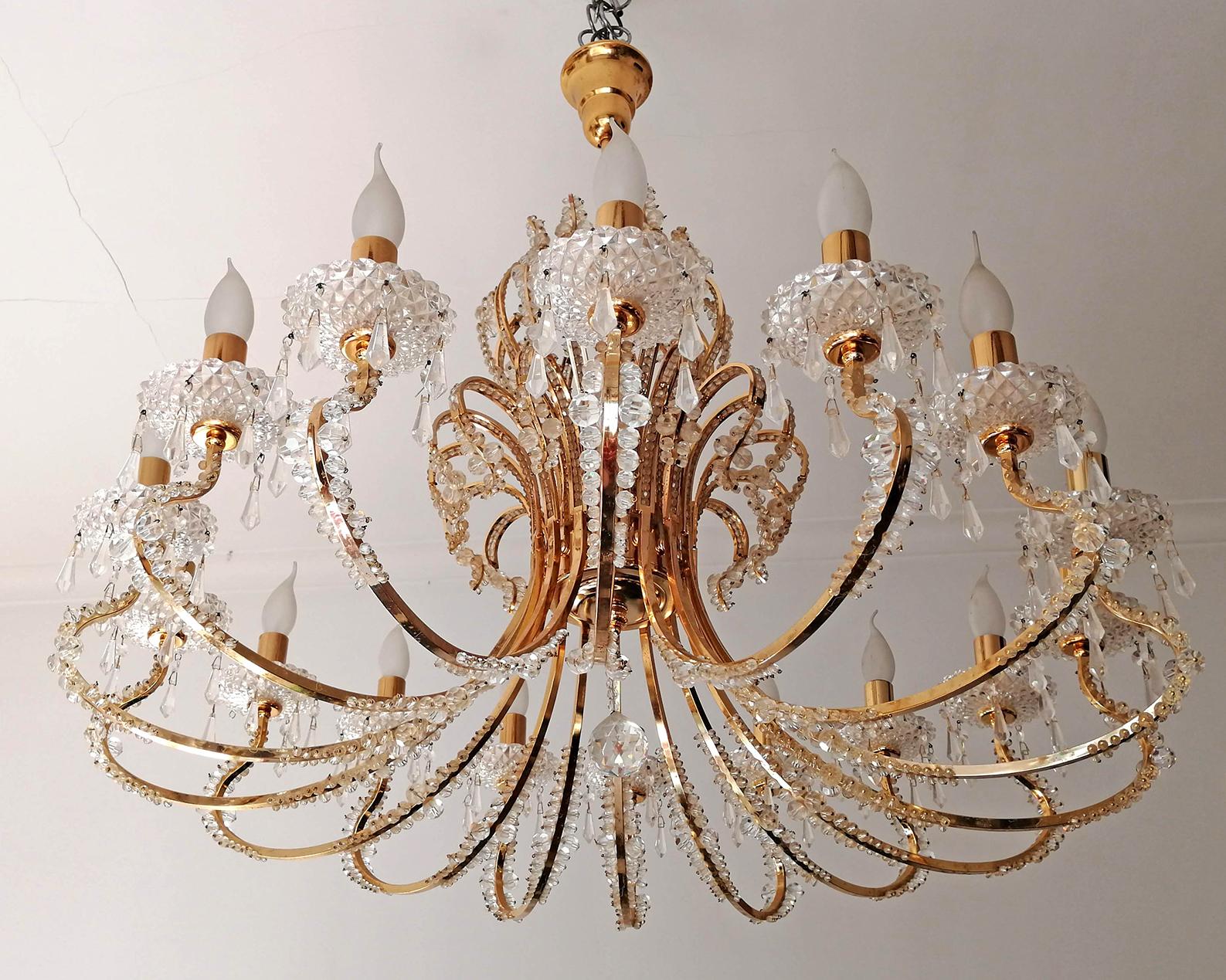 Stunning extra large impressive Empire cut crystal and gilt brass 19-light chandelier with crystal drops.
Measures:
Diameter 37.8 in/ 96 cm
Height 35.5 in / 90 cm
Weight 44 lb/20 Kg
19 light bulbs E14/ good working condition.
Assembly required.