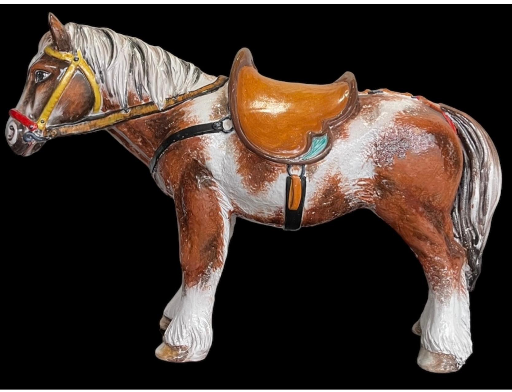 This is an amazing piece!  It is a Hollywood Regency Era Italian terracotta horse figurine. It appears to be a horse , as opposed to a pony, and the saddle and other accoutrement  are western in style. The thirty-eight inches in length is enormous