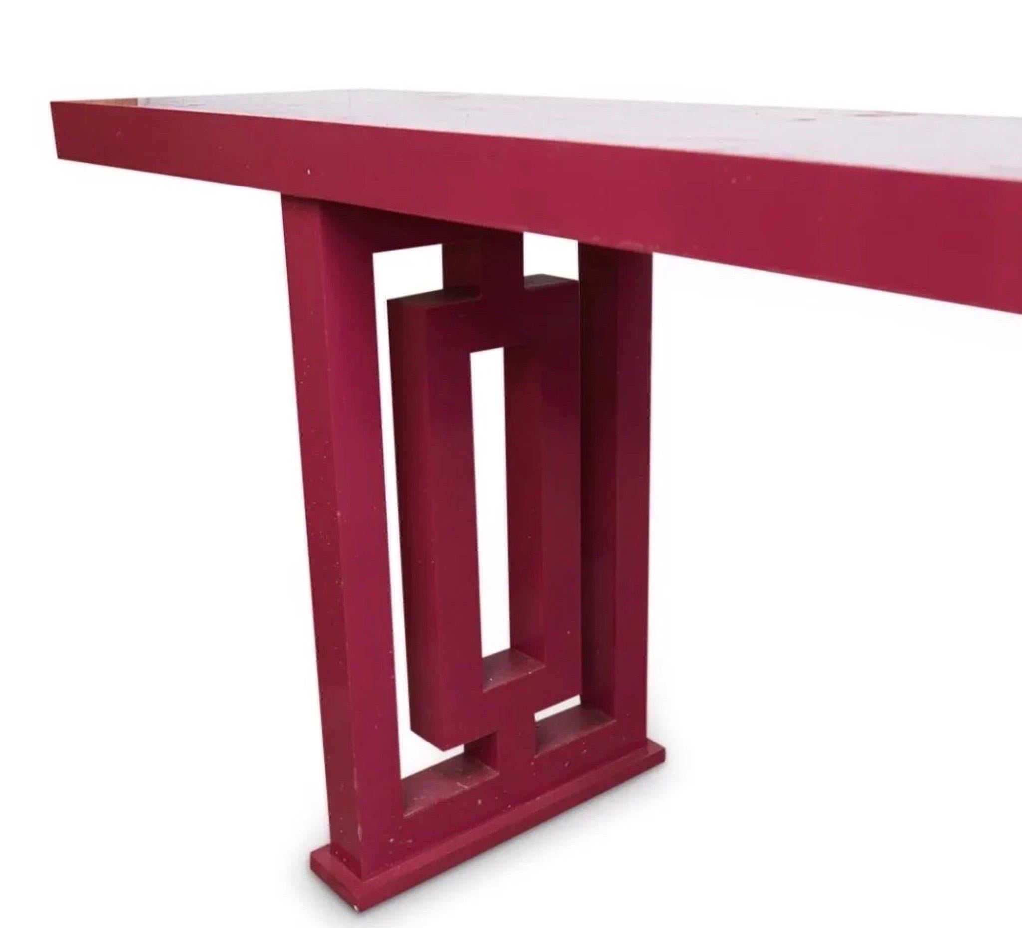 Monumental, Hollywood Regency altar table with pink lacquered wood design, constructed with a minimalist rectangular table top, raised on two pierced bases.