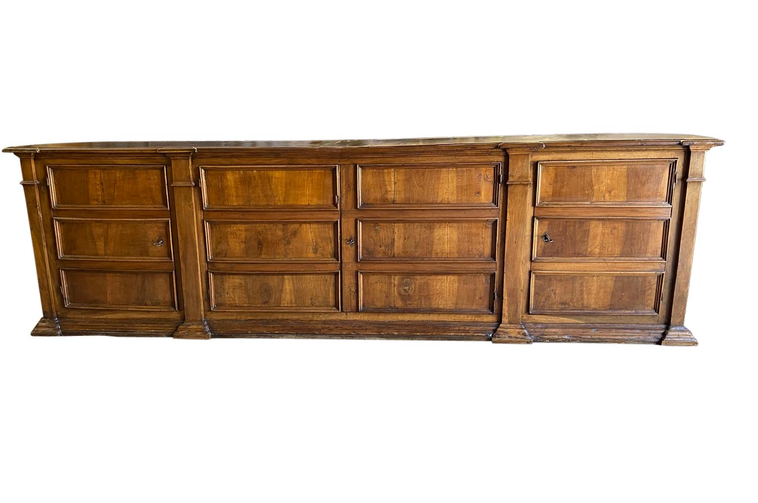 A monumental and exceptionally grand scale Italian Credenza beautifully constructed from stunning walnut. Excellent patina and graining. An absolute statement piece that will be the star of its surrounding.