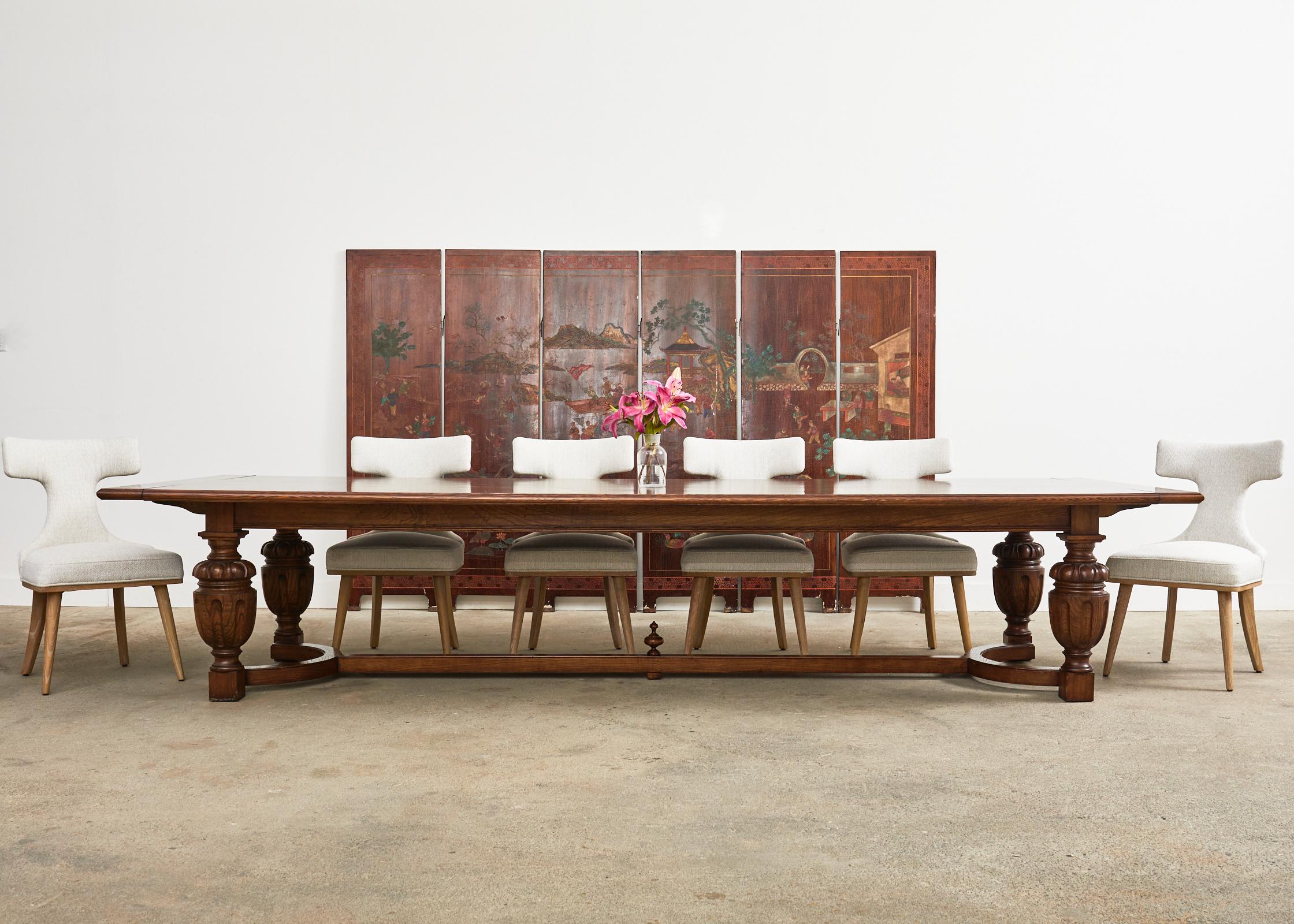Grand Italian refectory table or dining table crafted from oak in the baroque taste. The table is made on a monumental scale with two extending leaves measuring 20 inches each. Measuring 144 inches long when closed and 184 inches long with two