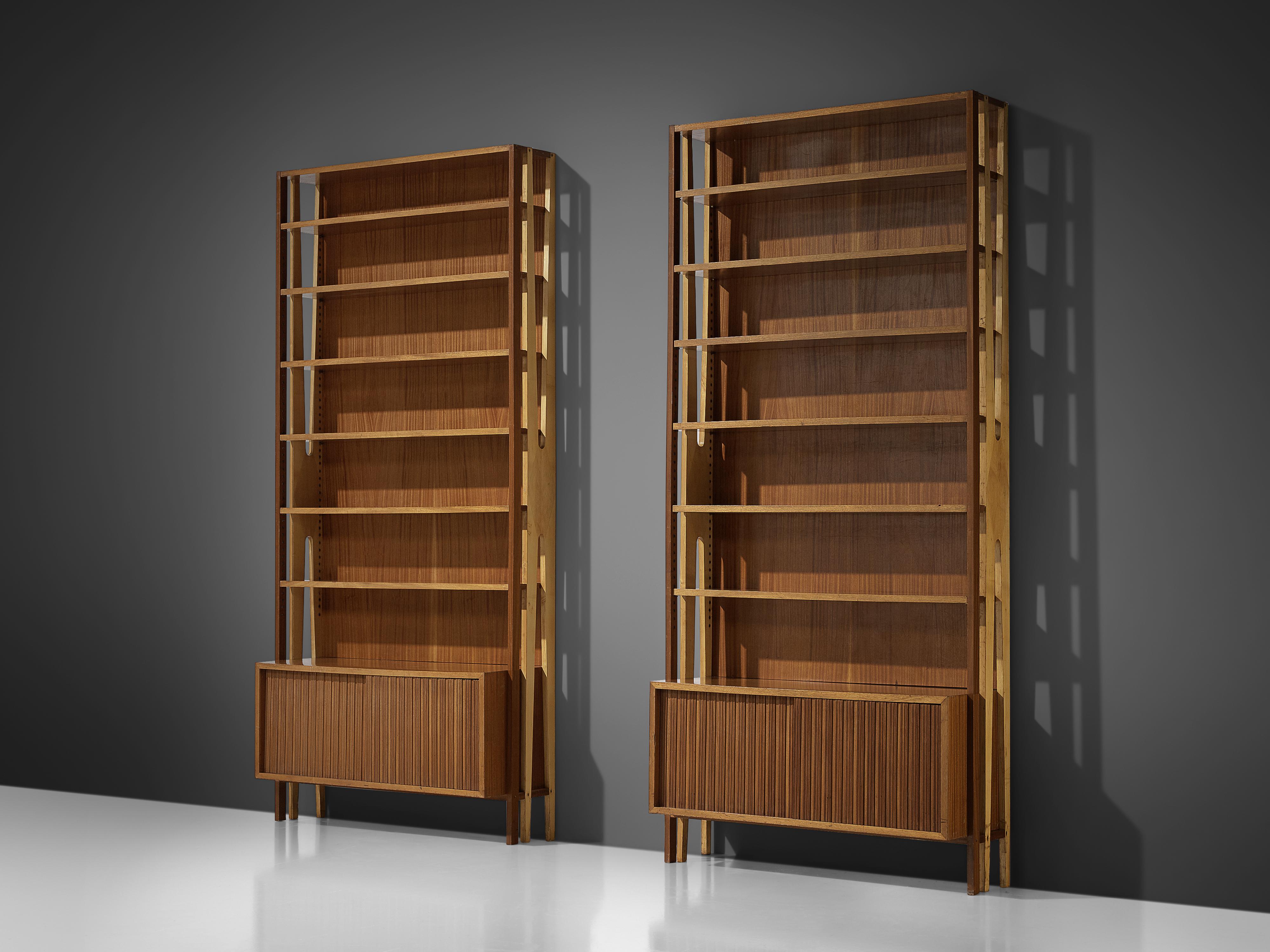 Two monumental bookcases, mahogany, Italy, 1960s

Large imposing bookcases, executed in refined mahogany. Both cases feature a large amount of shelves and storage compartments with sliding doors, making them very functional. The two bookcases can be
