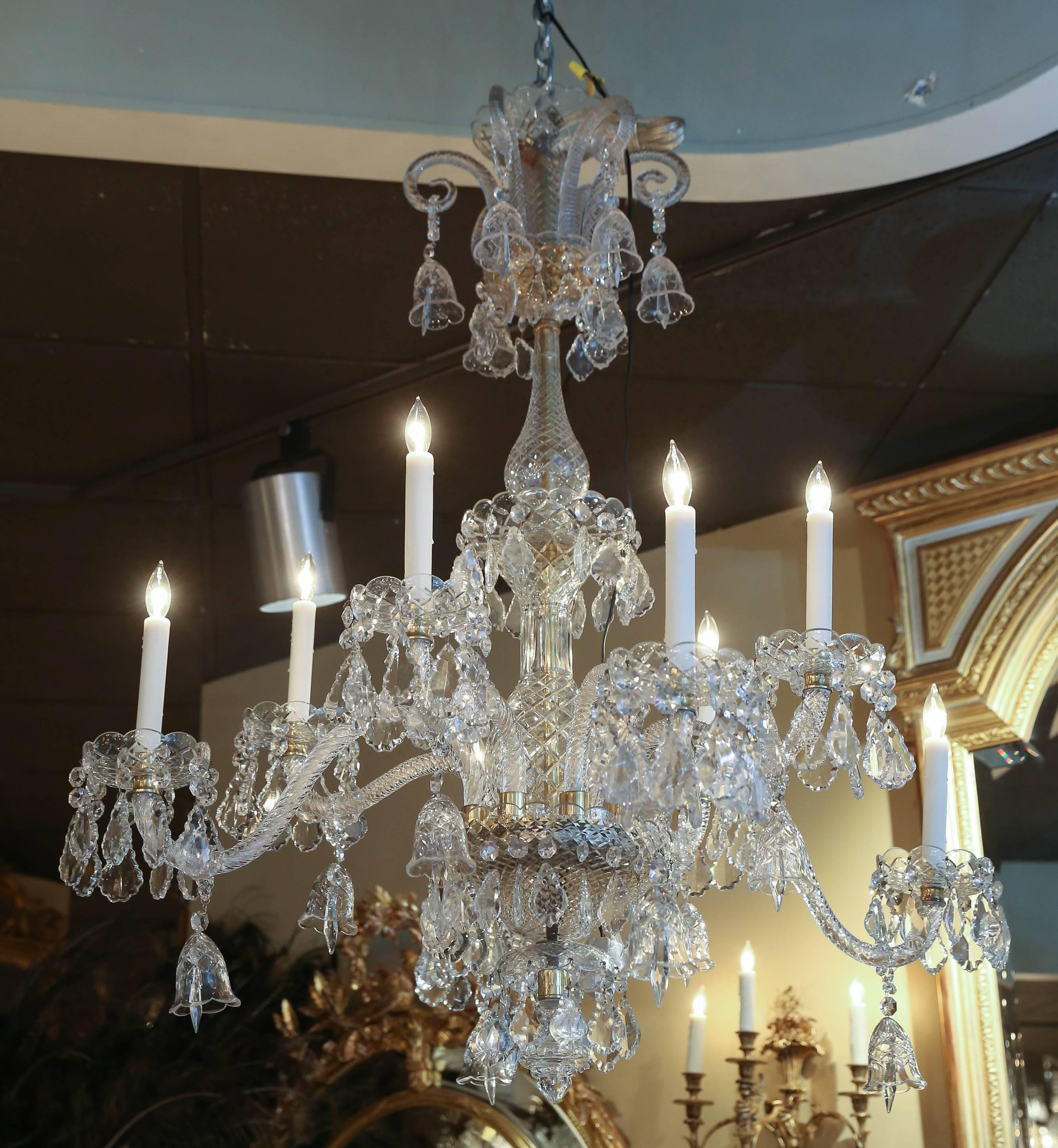 Large and beautiful eight-light chandelier, with drop prism accents throughout, having six scrolled arms to top,
hung with crystal bells, vasiform standards, eight curved
and spiralled arms, ending in bobeches, and fitted for
electrical. The wiring