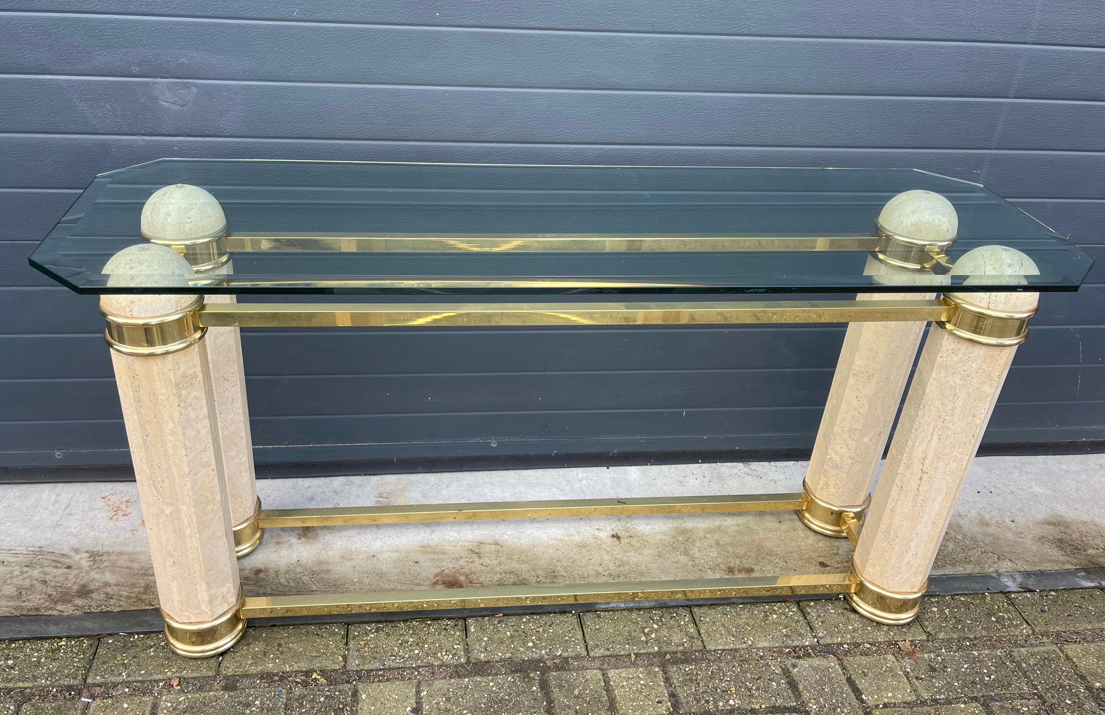 Monumental Italian Console Table in Travertine, Brass & Beveled Glass, 1980s.

This striking Italian console table from the 1980s is a masterclass in bold, luxurious design. Crafted in Italy with architectural precision, it combines natural