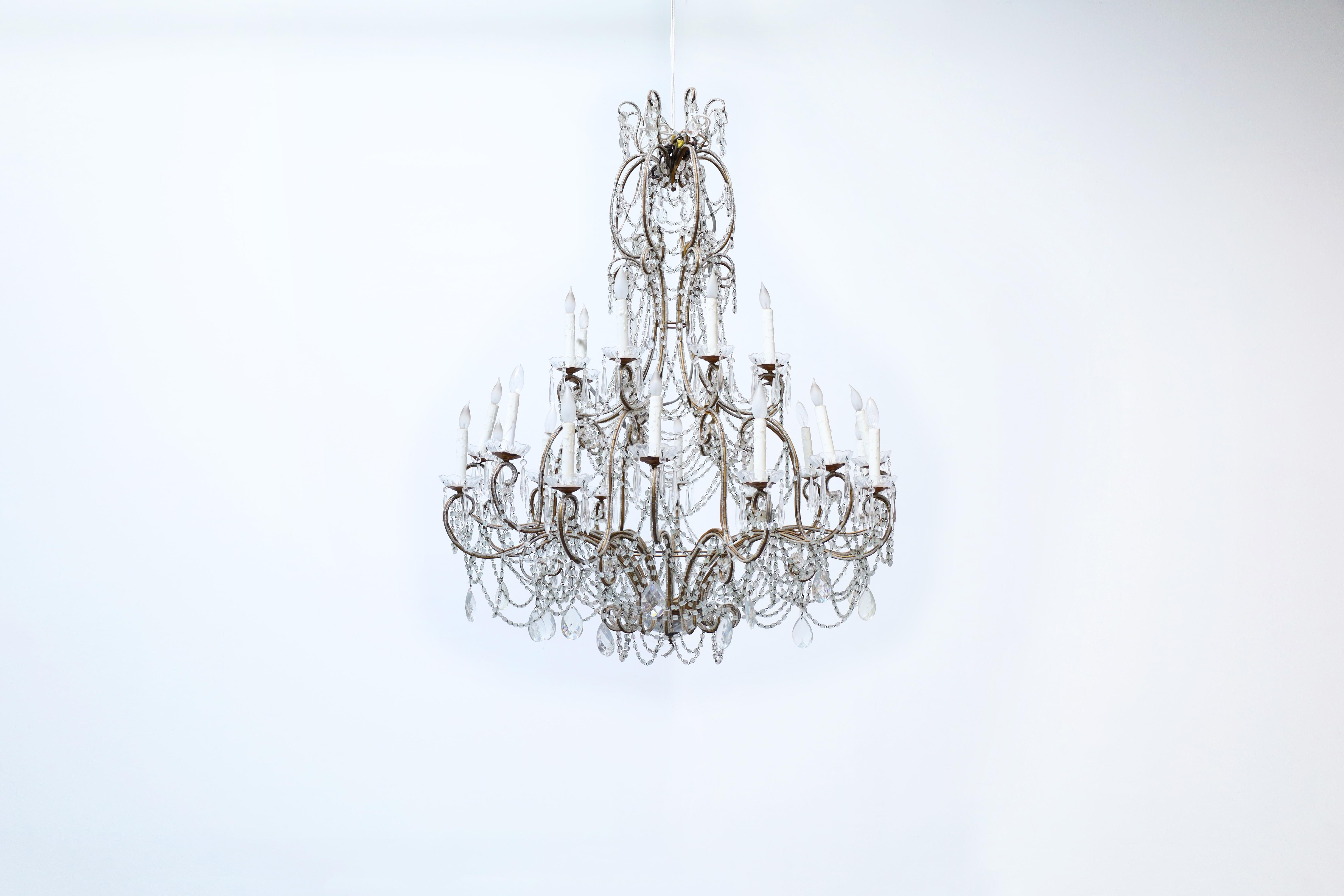 Wonderful monumental Italian crystal and gilt chandelier designed and manufactured in Italy. This chandelier stands out for its fine workmanship and fascinating mix of materials that any viewer will admire. It features a design that appears to be in