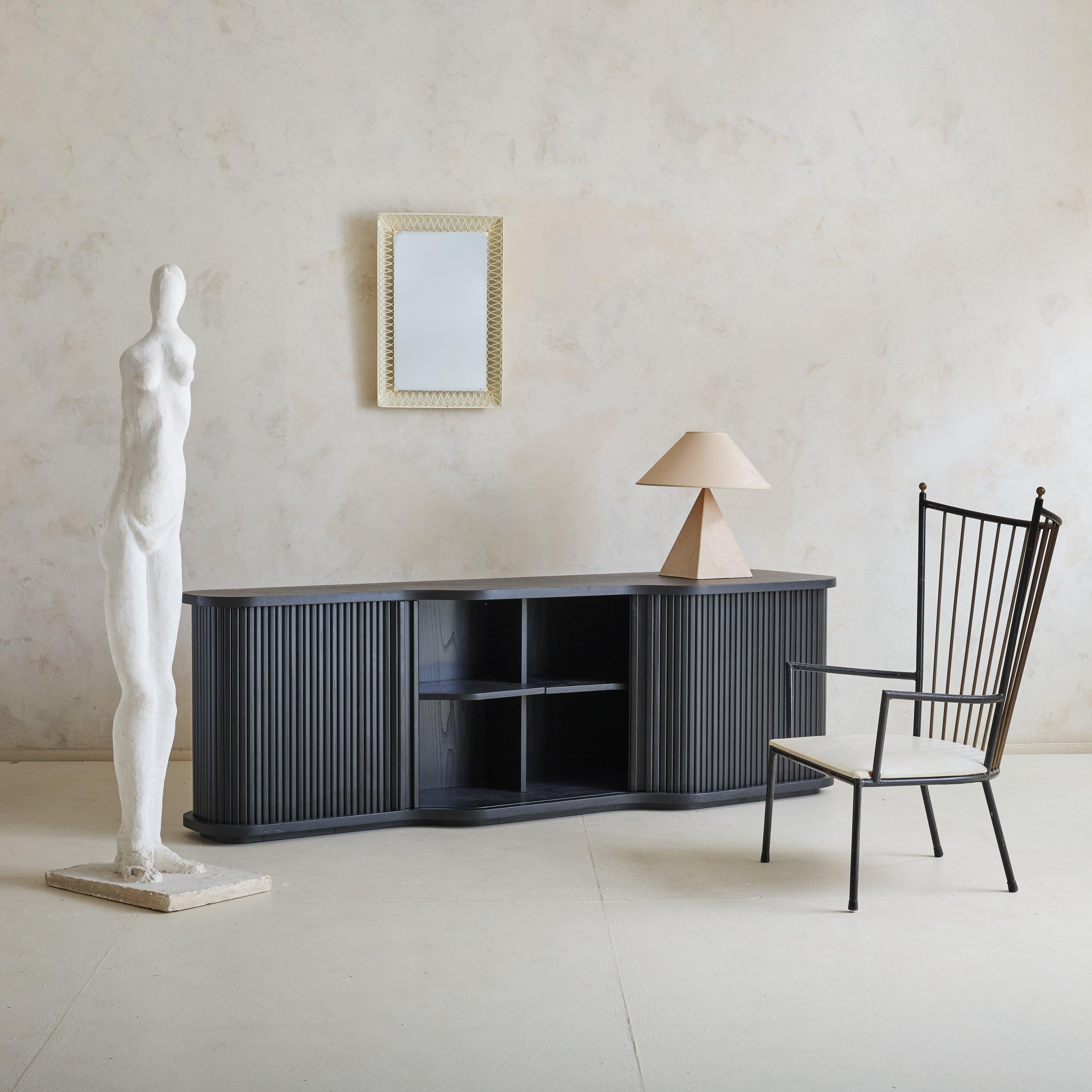 Originally crafted for an esteemed Italian architect's personal collection in the 1980s, this credenza is defined by elegant proportions and an architectural presence. Its sculptural silhouette, with gentle asymmetrical curves, softens the rich