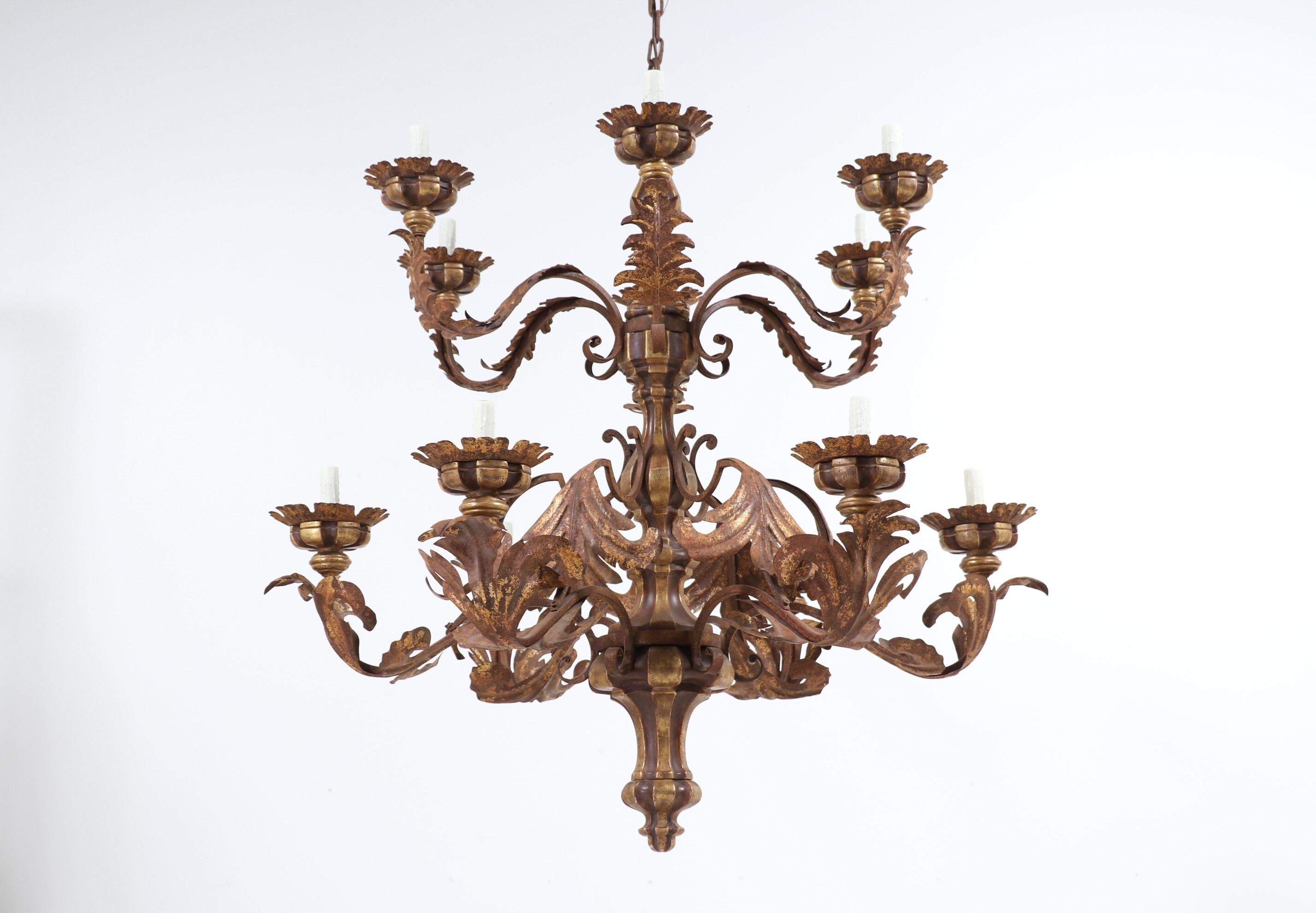 One of a pair available. Price is per item.

Monumental, Italian-style painted and parcel-gilt carved wood “Seasons” chandelier by Paul Ferrante. 

This impressive, 2-tier chandelier consists of carved, gilded-wood components and 12 leafy iron arms