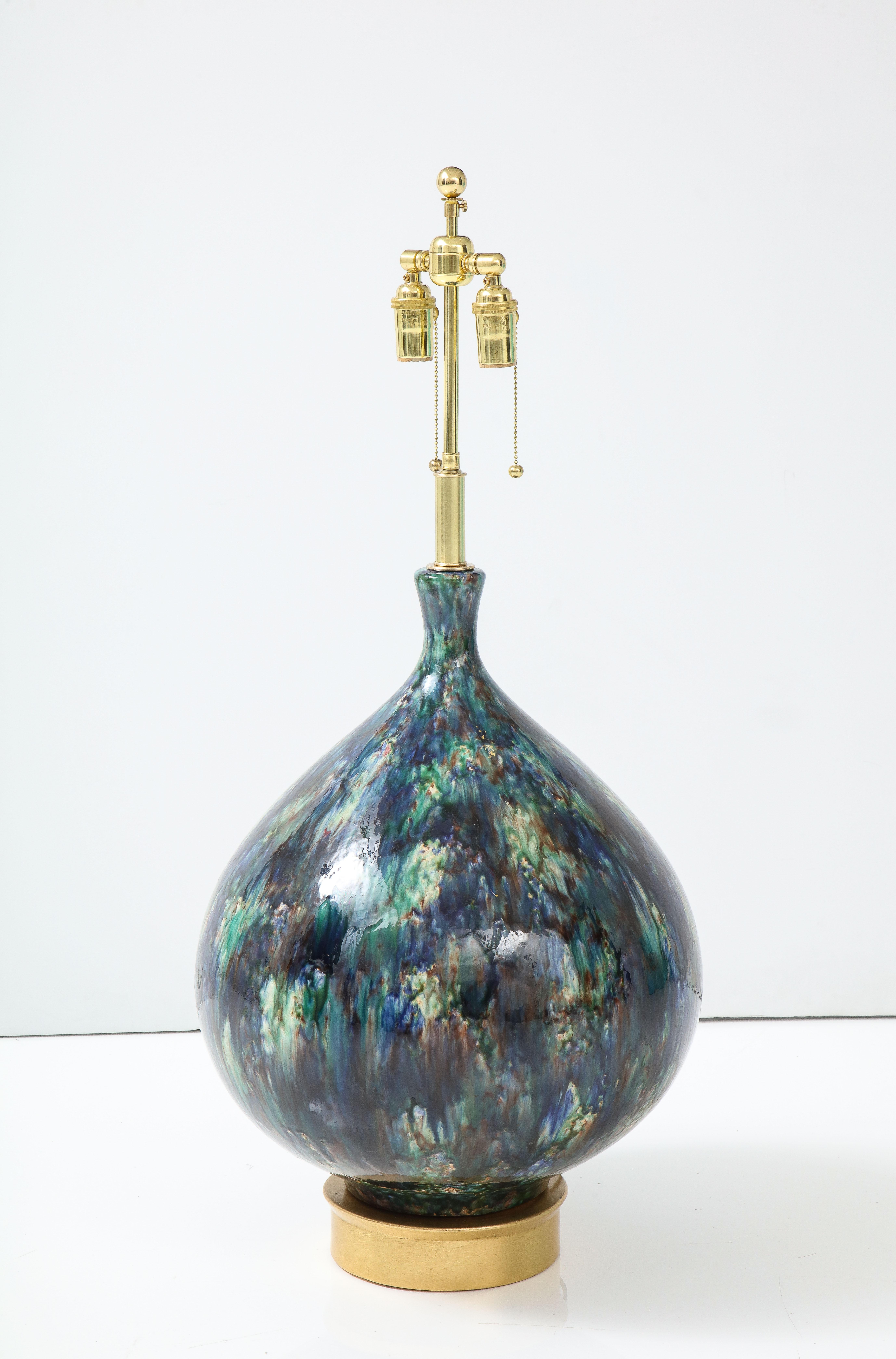 1960's Monumental Italian ceramic lamp with a beautiful glazed finish.
The lamp sits on a gilt leafed wooden base and has been Newly rewired 
with an adjustable polished brass double cluster.
The height to the Top of the ceramic is 24