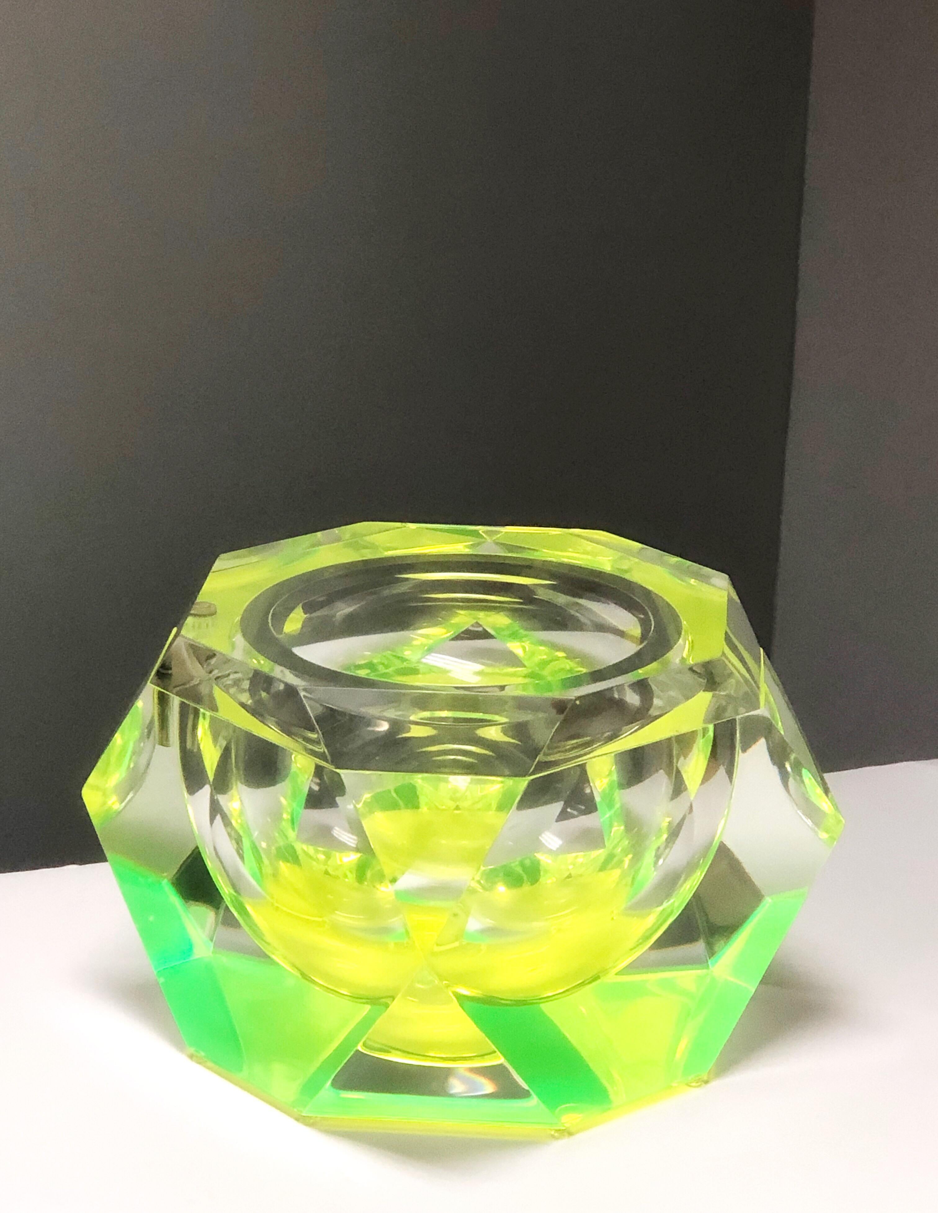 A large Lucite ice bucket, Italian 1970s. Swivel top. Lots of facets refract the neon green color.