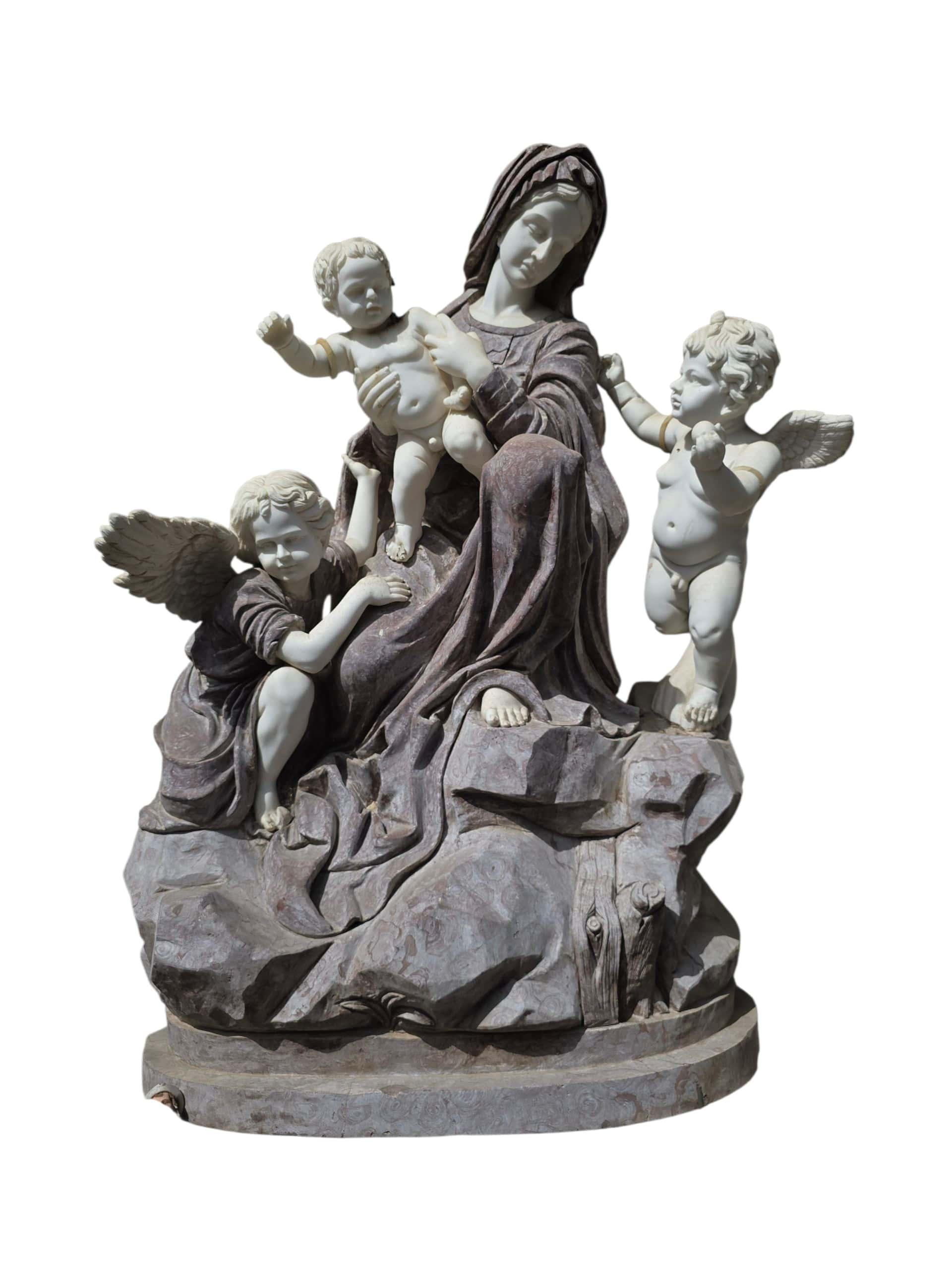 Magnificent Italian sculpture of the Virgin Mary surrounded by cherubs, carved in the 20th century from fine multicolored marble. Executed with exceptional craftsmanship, the composition captures a serene and graceful Madonna figure elevated above a
