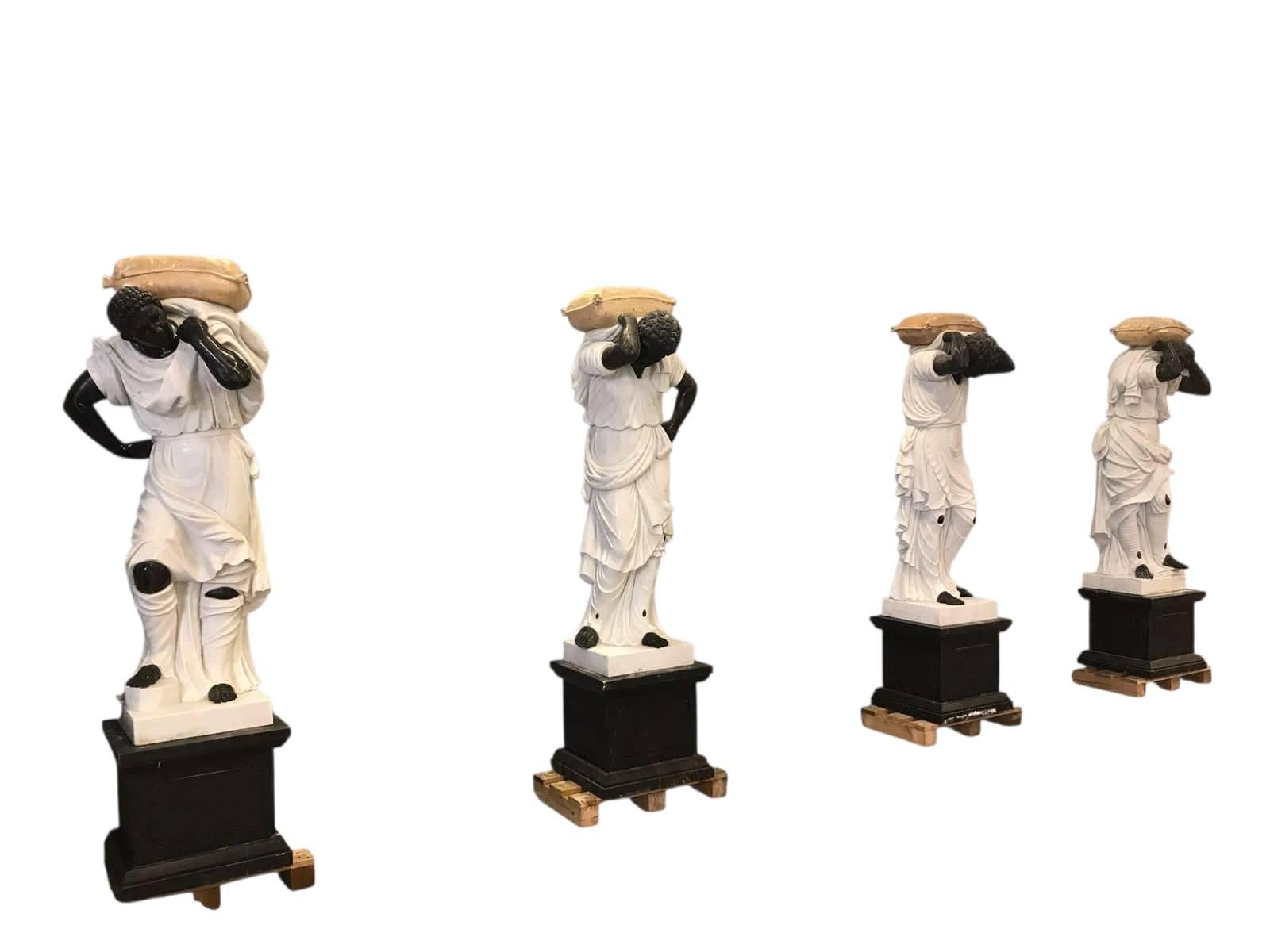 Exceptional and monumental set of marble sculptures representing an allegory of the Four Seasons, carved in Italy in the 20th century. Each figure is executed in a combination of white and black marble, emphasizing the contrast in drapery and