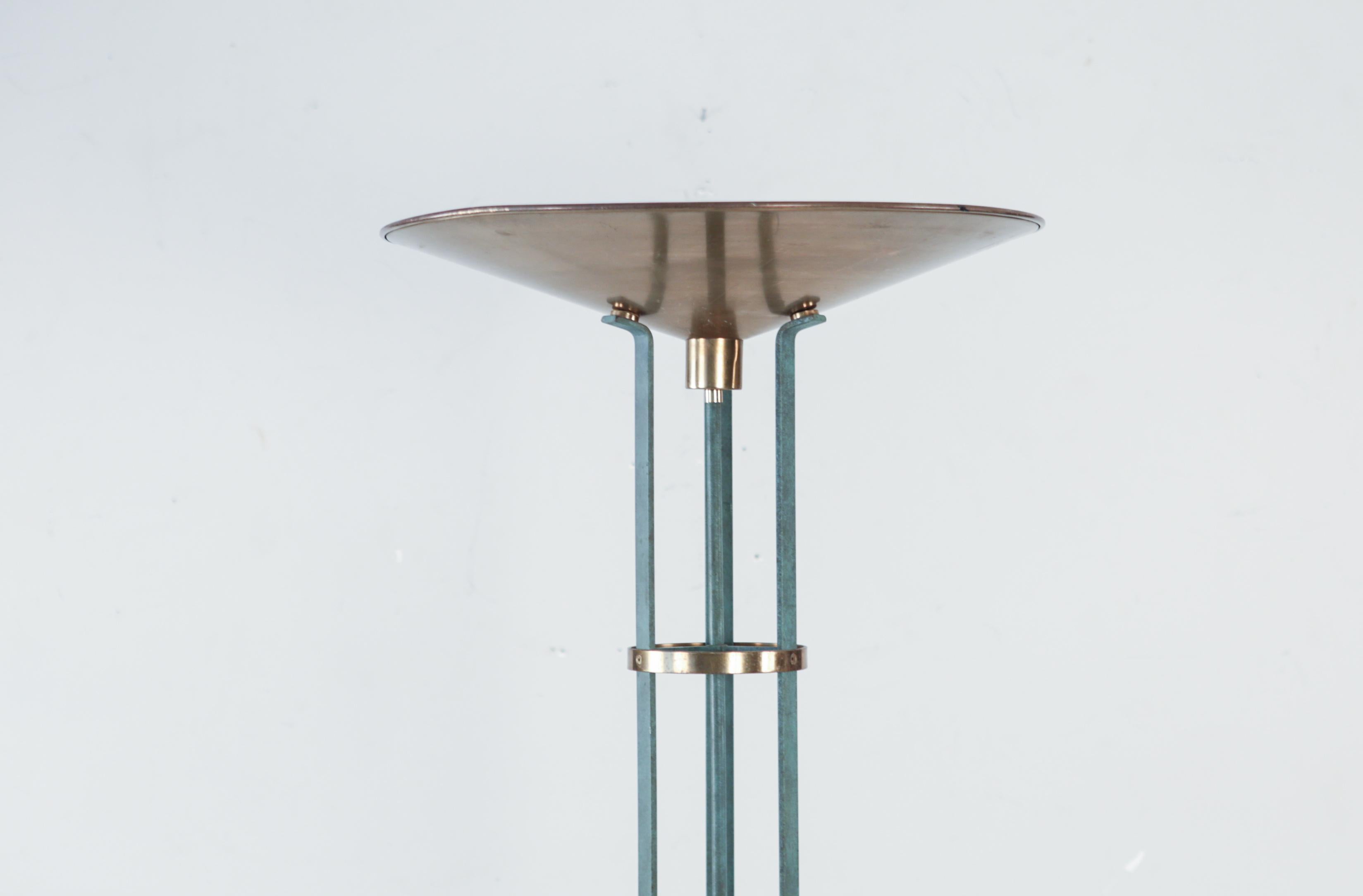 Evoke the drama and glory of the Olympic torch with this imposing torchiere-style floor lamp. Standing over six feet high, this sleek piece features faux-verdigris painted iron legs, polished brass accents, and a stunning brass bowl.