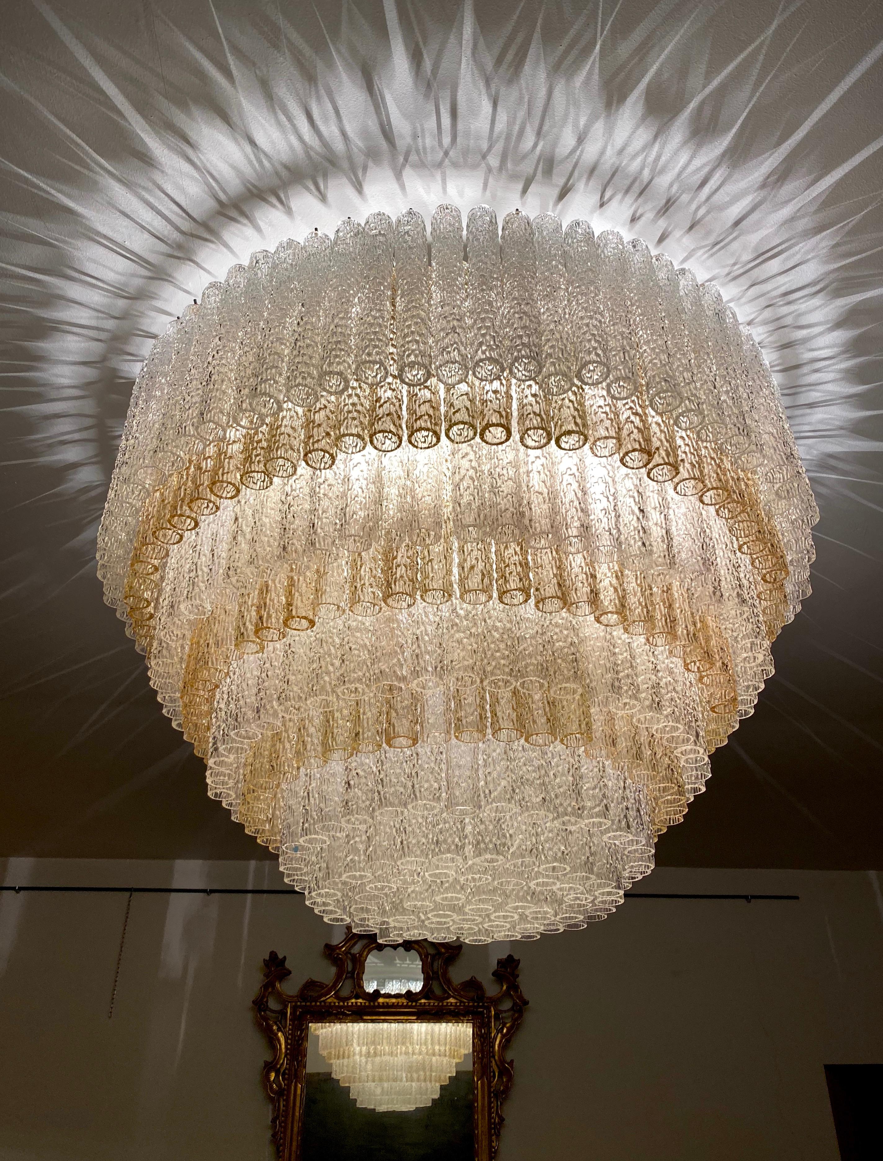 This extraordinary chandeliers is composed by hundreds of precious 'Tronchi' Murano glasses on eight levels with clear and grey fumé color glasses.
designed by Gino Poli, for Aureliano Toso, circa 1966.
Available also 3 pairs of sconces from the