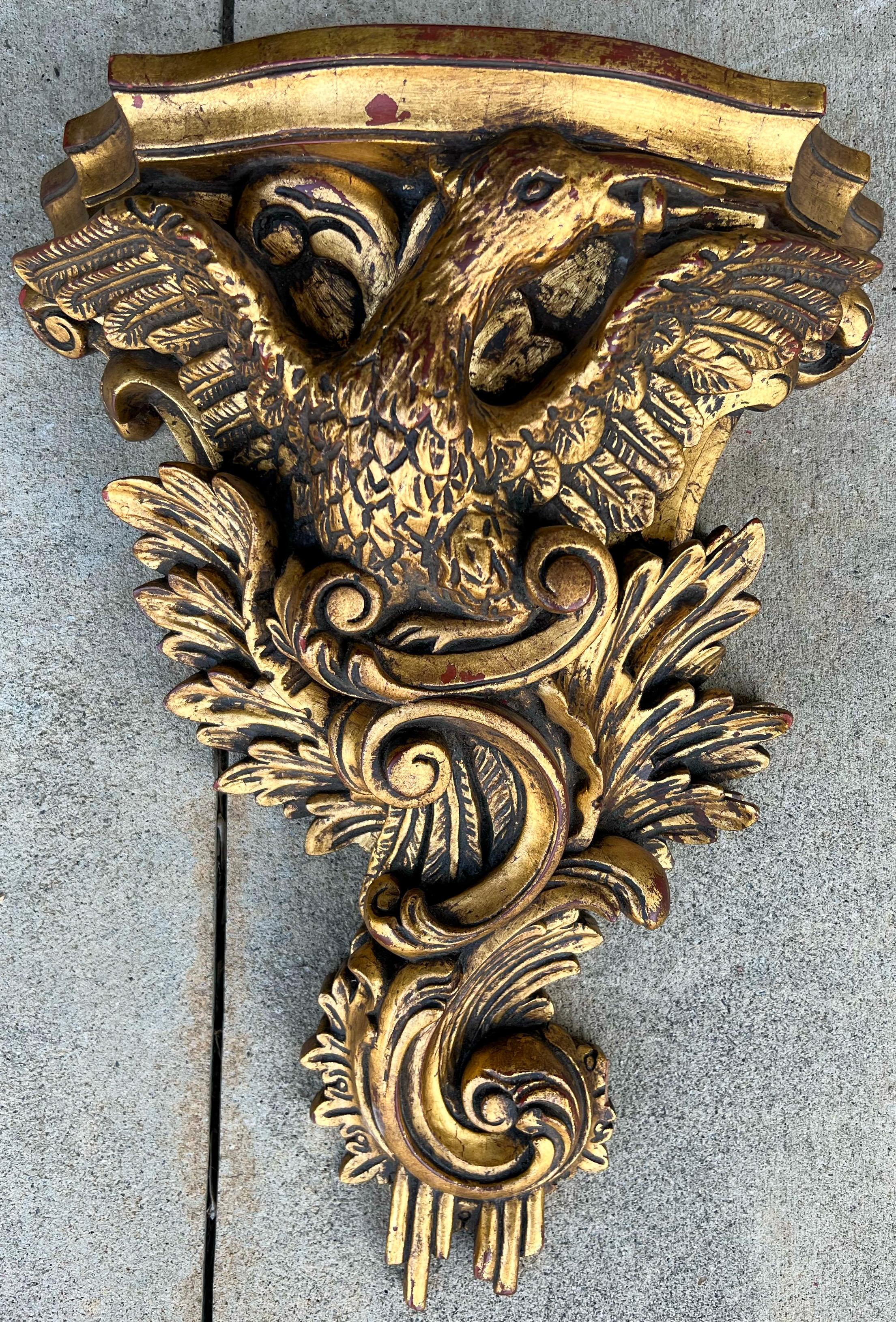 This is a very large scale Italian carved giltwood wall bracket. It is a majestic mid-century piece. I believe the bird to be a Ho Ho bird, but it could also be an eagle. It is in very good condition.