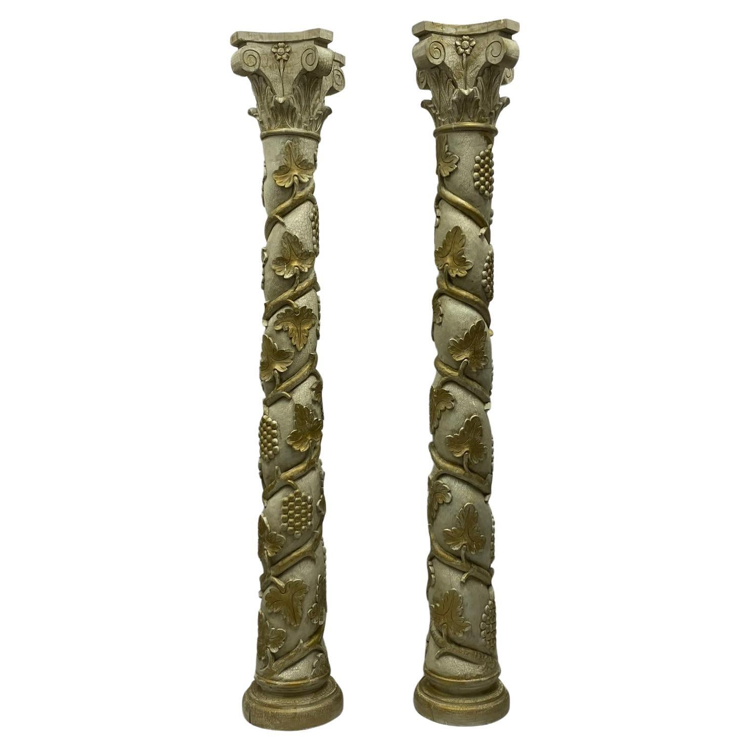 This is a monumental Italian neo-classical style carved and painted columns with cascading grapes and vines. They are most likely mid-century pieces and do have age appropriate wear.