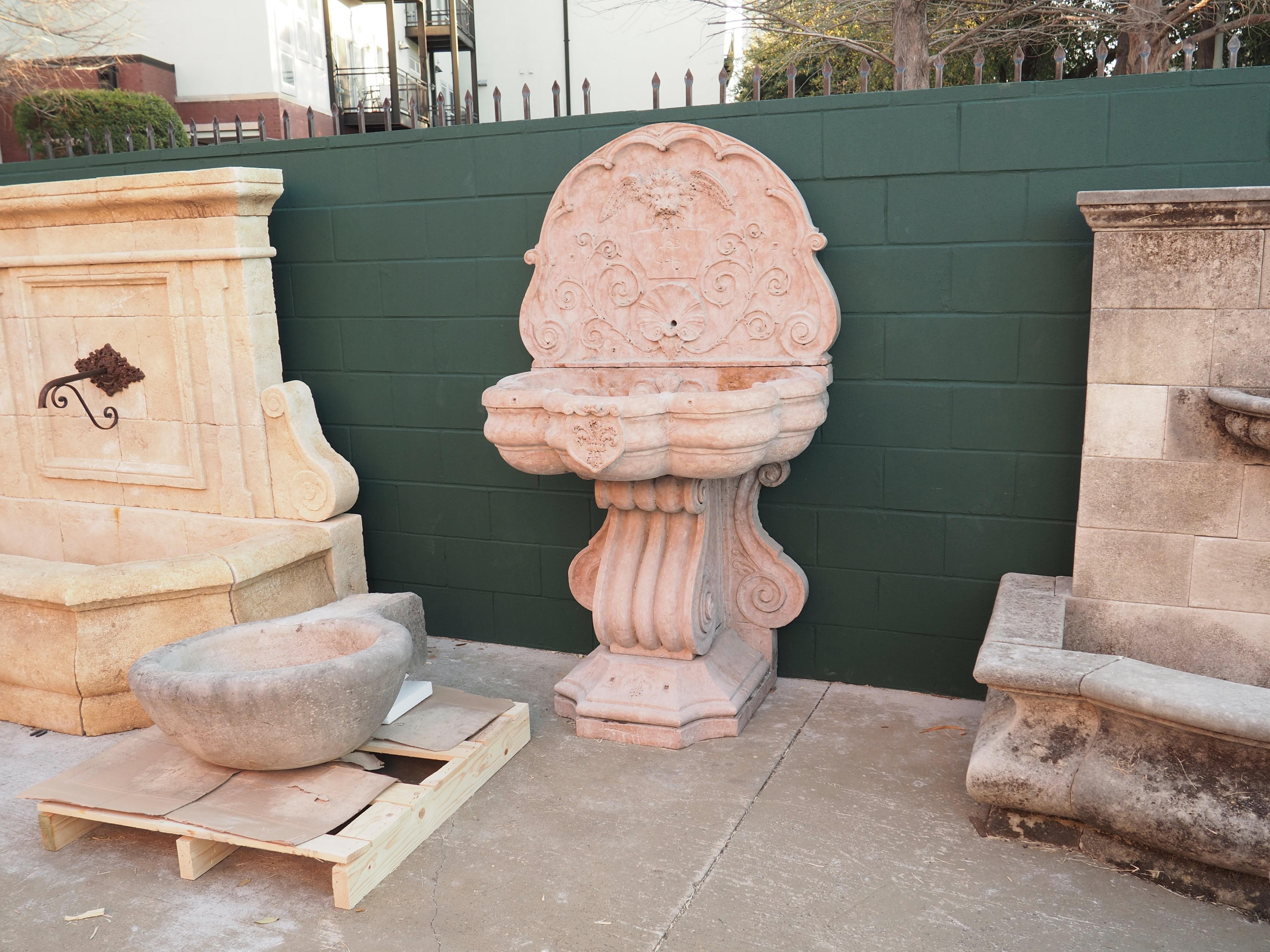 This monumental Italian wall fountain was hand-carved in verona rossa marble in the early 1900’s. Truly the work of a master mason, the fountain is comprised of three thick pieces of richly carved marble, with each piece weighing several hundred