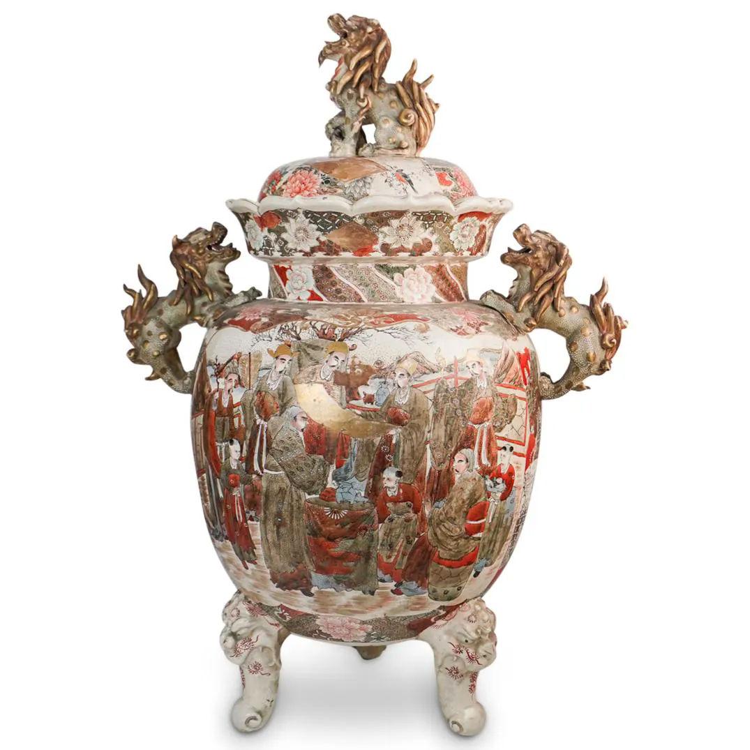 Monumental Japanese Meiji Period Satsuma tripod covered vase with foo dog handles and finial.
