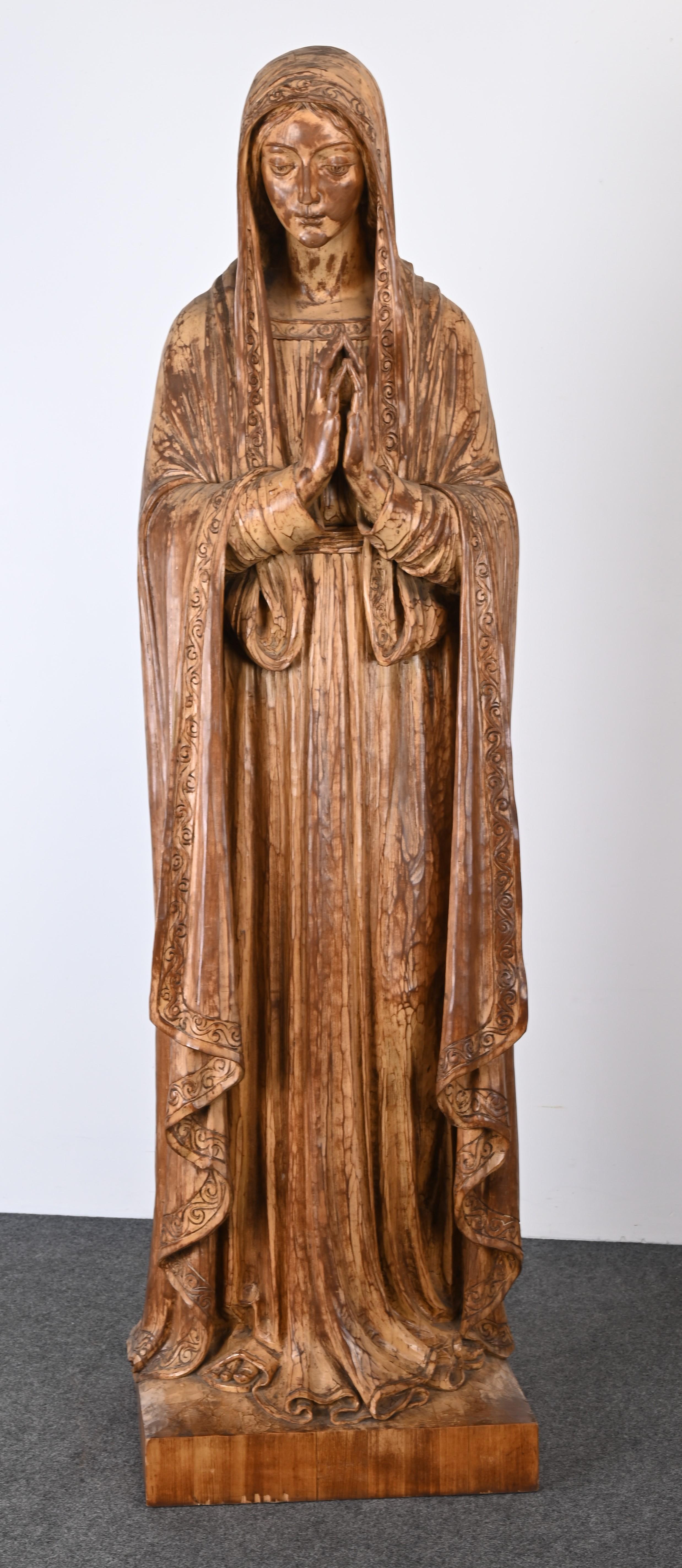 A religious pair of monumental wooden sculptures depicting Jesus and Mary from the Berks County Pennsylvania Jesuit Center. This dynamic hand-carved pair of folk art statutes were probably commissioned specially for the Jesuit Center. Carved with an
