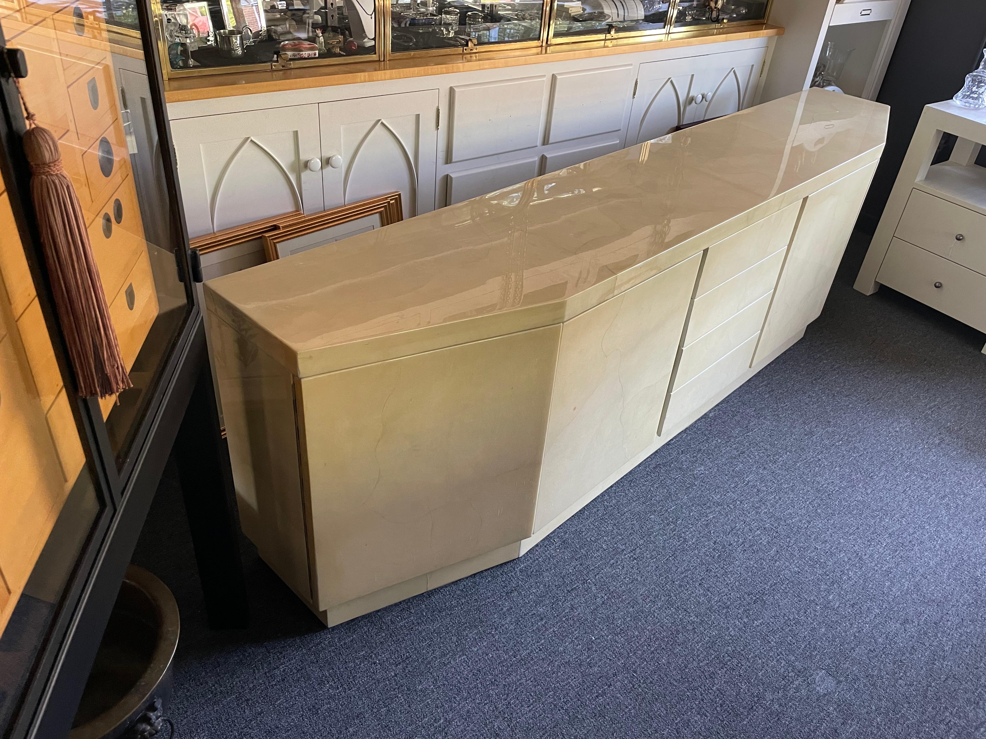 A monumentally large Karl Springer custom angular credenza in a creamy, ultra-luxurious goatskin. The goat skin hides on the front have a wonderfully matched curved detail that makes this piece very stylish. Beautiful used condition.