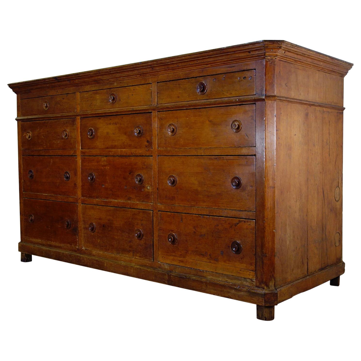 A superb 19th century Italian bank of drawers, of extremely large proportions displaying a rich and warm patination throughout. An imposing and majestic piece, demonstrating a usually grand depth, with twelve graduated drawers displaying charming