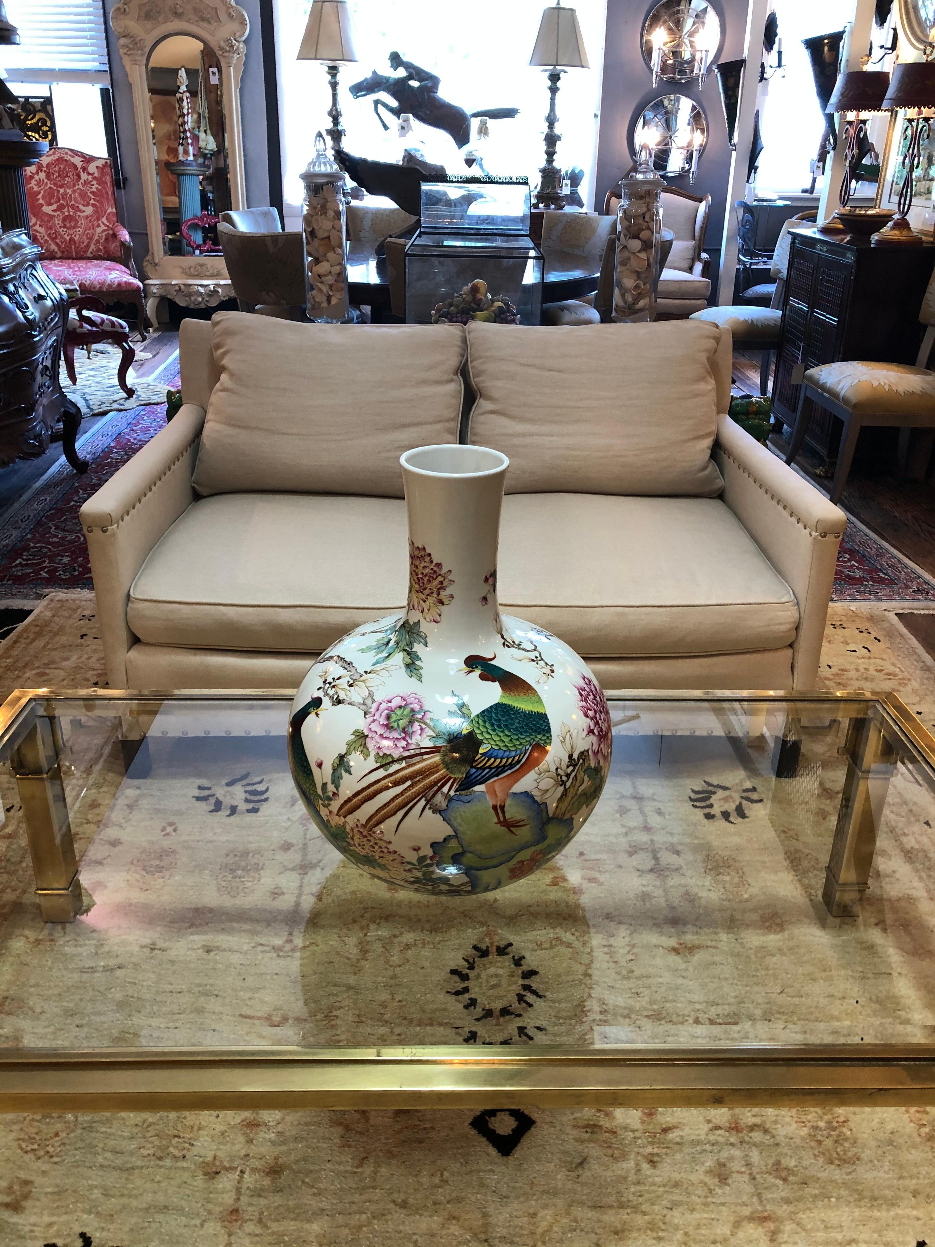 A magnificent and impressively large Chinese vase hand painted with pheasant and peonies in shades of green, black and pink on white porcelain.