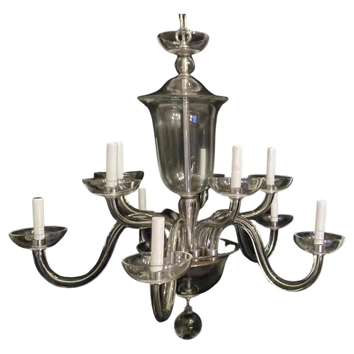 A monumental and elegant crystal / glass Mid-Century Modern nine-light chandelier with scrolls and S Form arms leading to a classic clear bobeches & polished nickel fittings, wiring has been updated and comes ready to install and enjoy.

Measures: