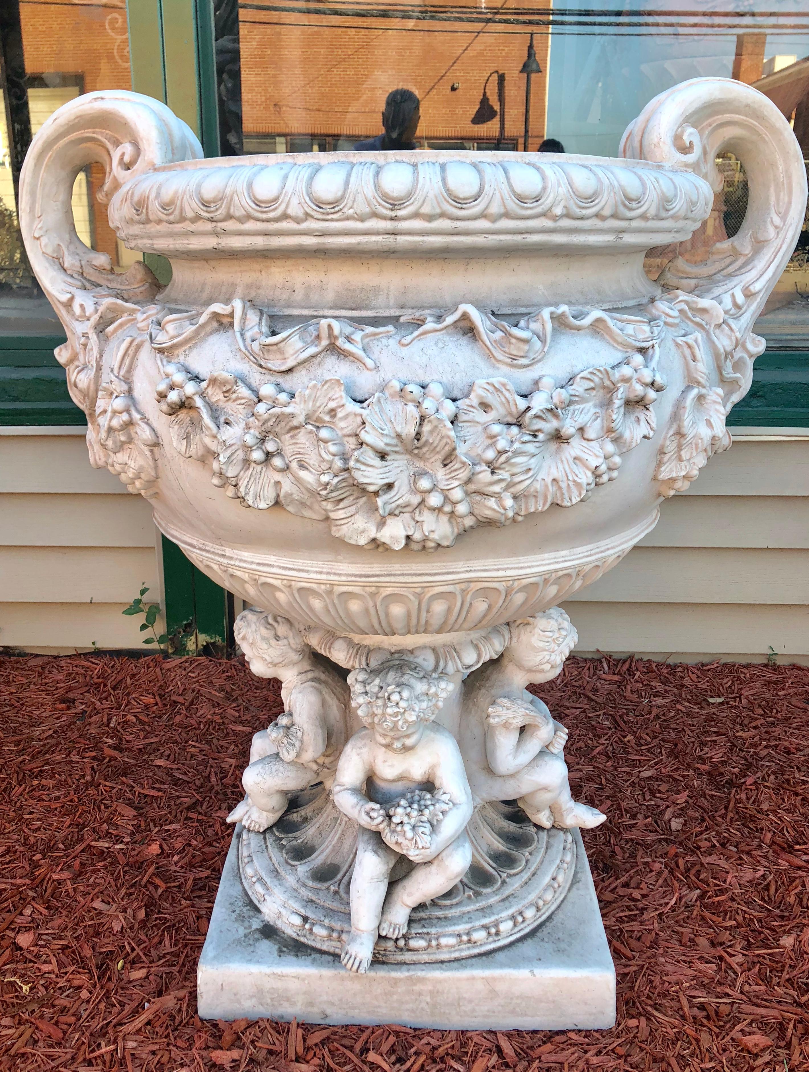 Monumental large fiberglass or resin cherub planter the cherub in the planter is 15 inches in height.