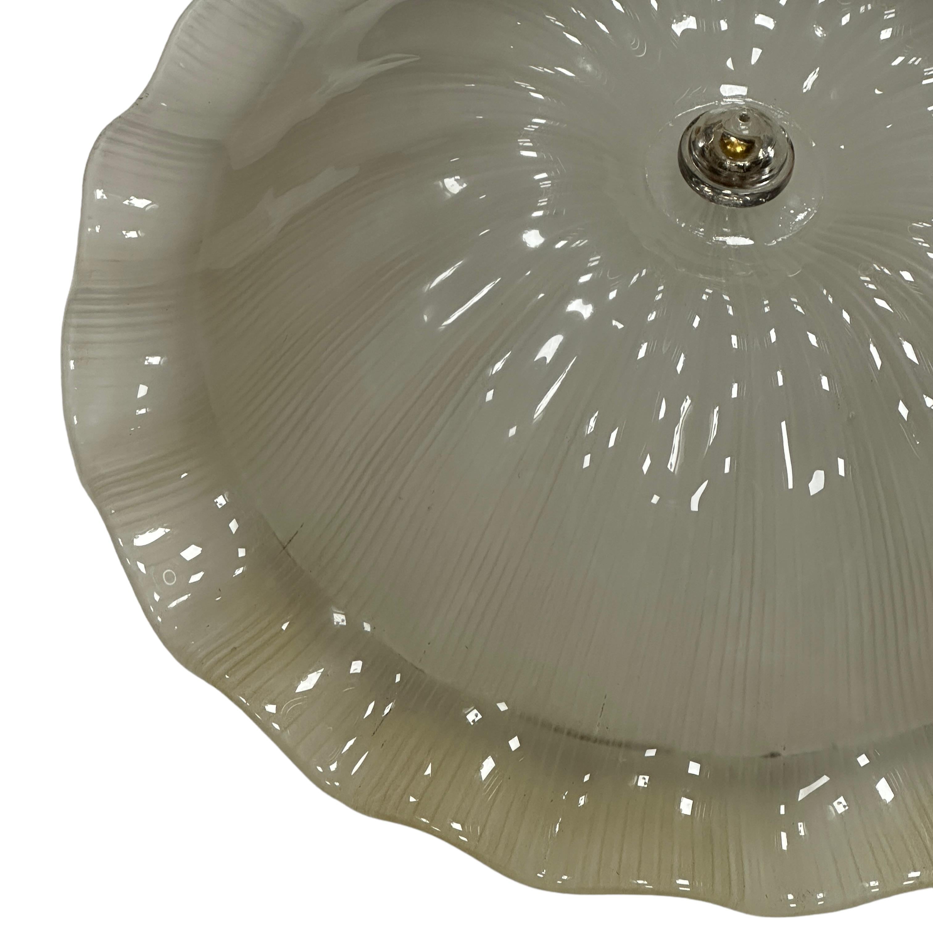 This exquisite flush mount chandelier in style of the legendary atelier of Venini in Italy, circa 1970s. It features a subtly concave and channeled hand blown thick and heavy Murano glass shade. With its clean modernist lines and timeless