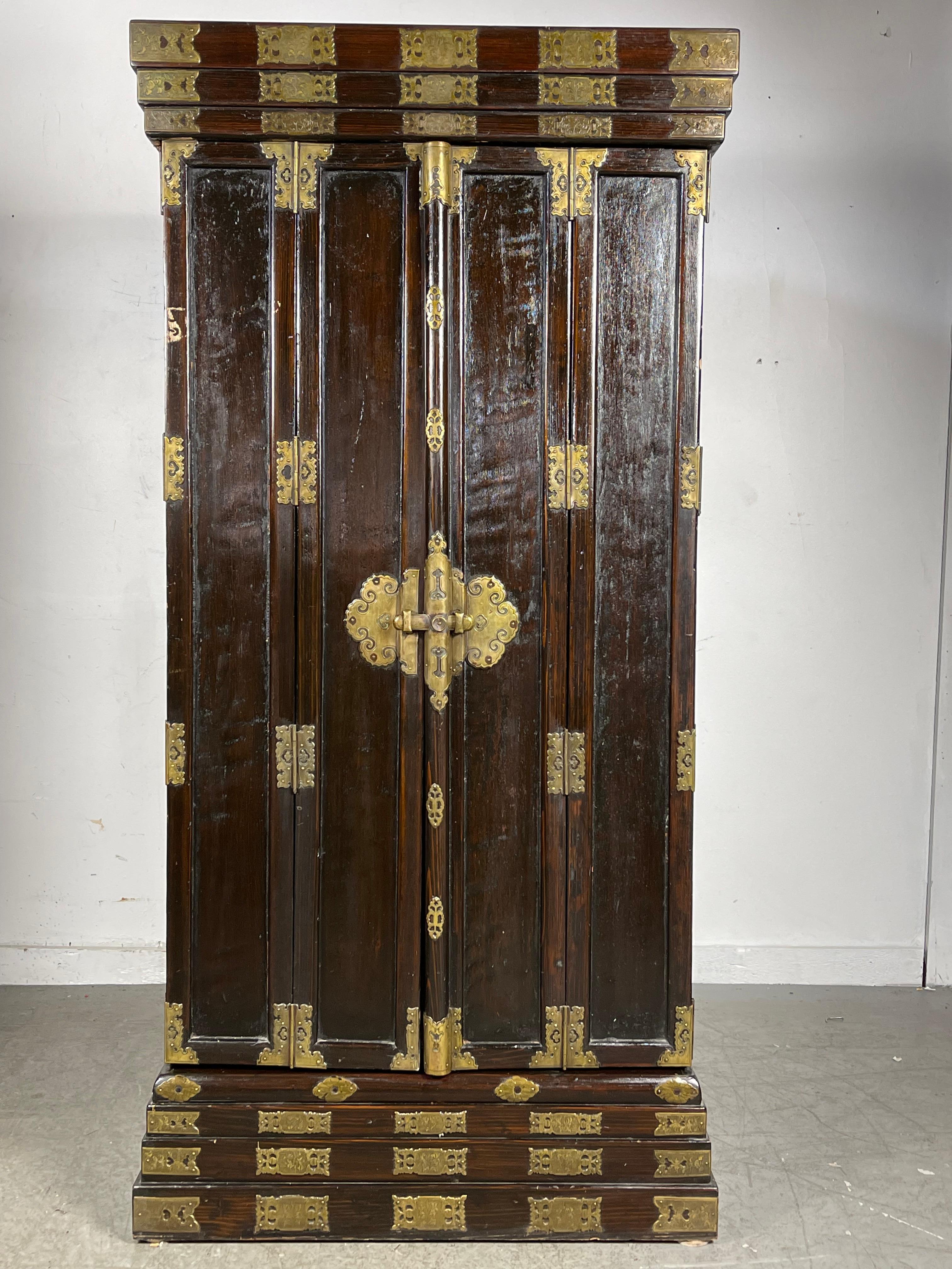 Late 19th century Monumental Japanese black lacquered shrine with finely detailed patinated brass fittings / two hinged doors / gilded brass enameled upper arch / fully gilded interior / carved gilt wood ,, Very fine detailed carvings with all