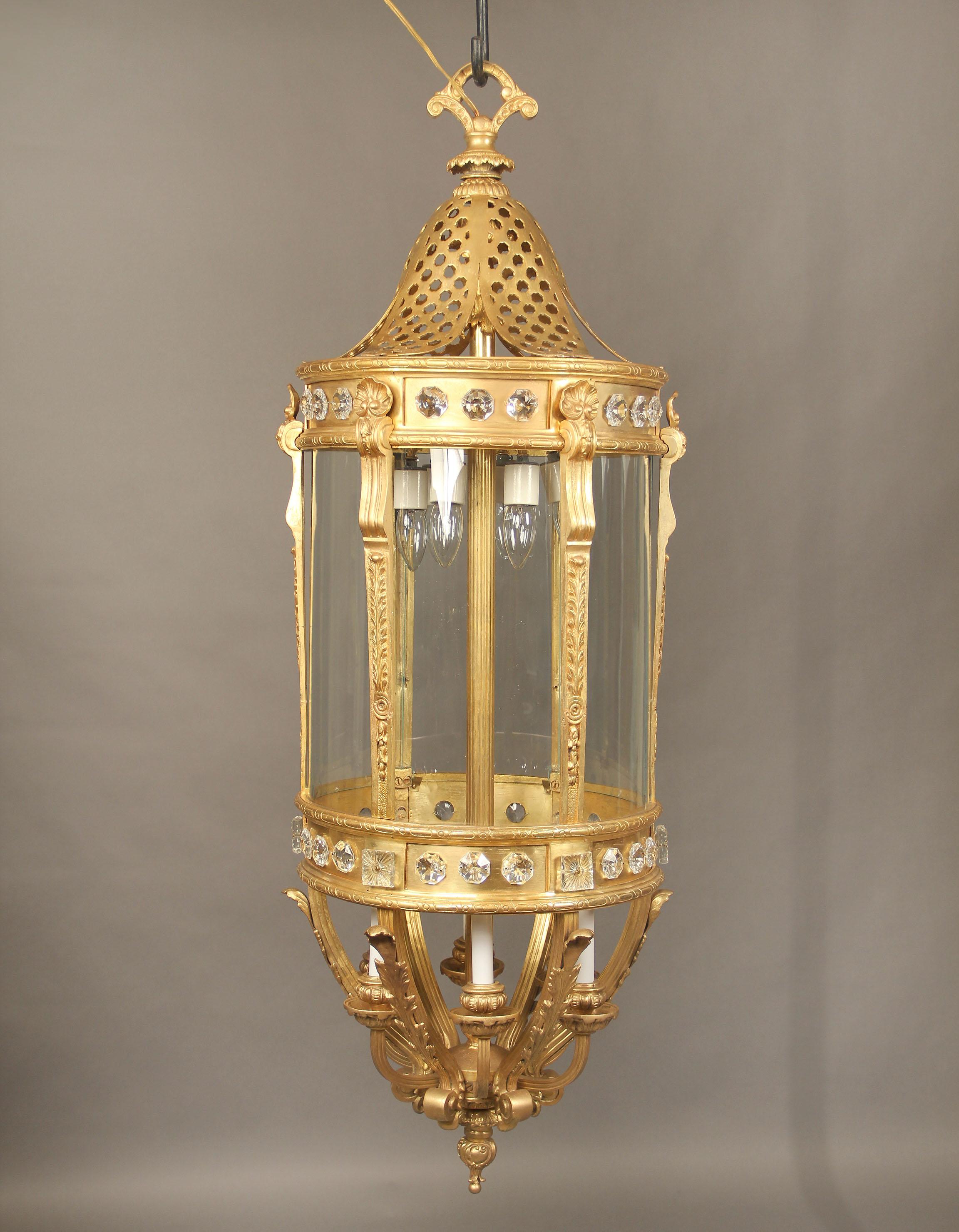 A monumental late 19th century gilt bronze and crystal twelve-light lantern.

Long and oval form with crystals around the body, six lower and six upper interior lights.