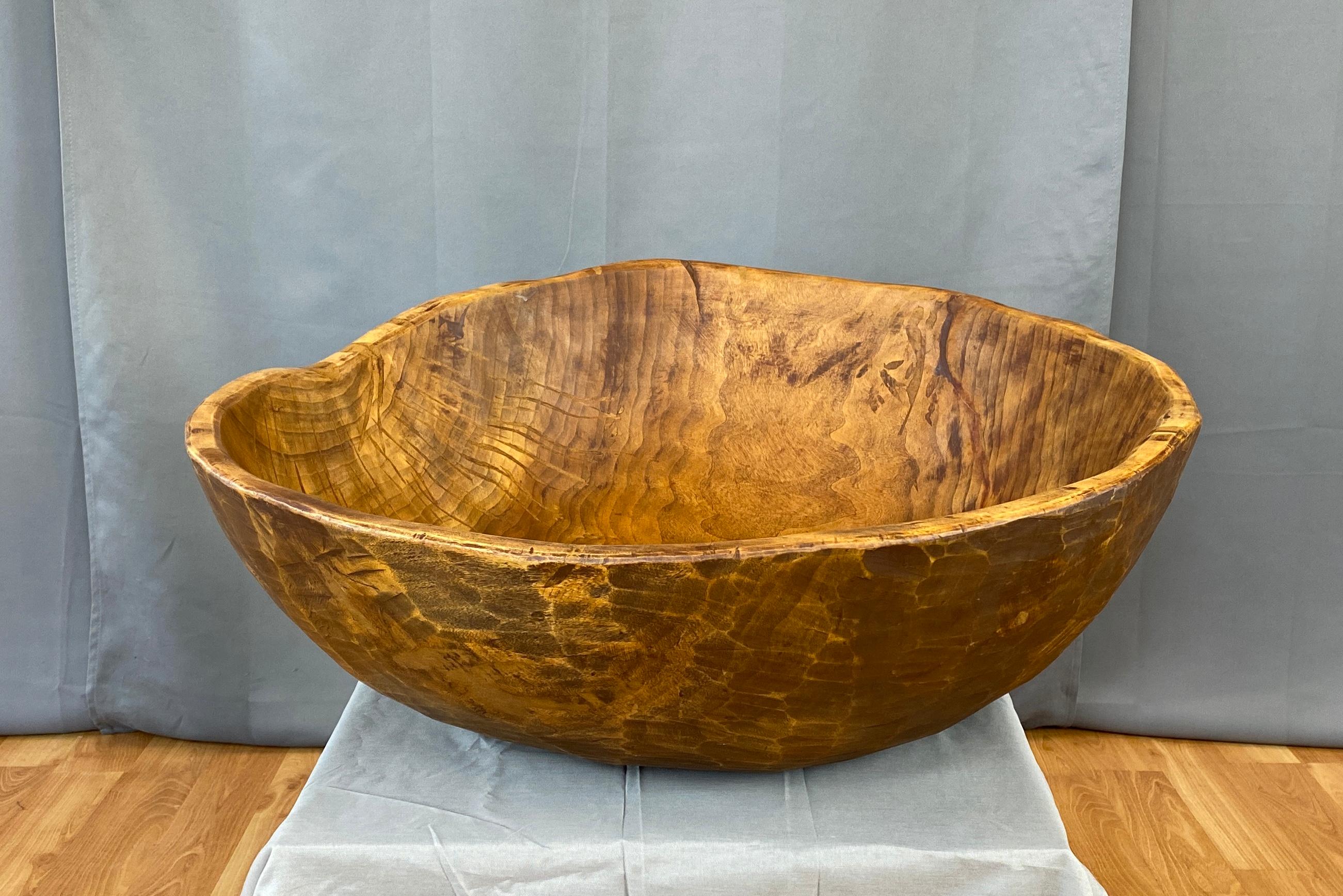 Offered here is an extra large late 20th Century hand carved wooden bowl.
This uncommon size would have taken the craftsperson many weeks, with great care, carving this one piece of wood.
Not sure of the type of wood, but it has beautiful patina