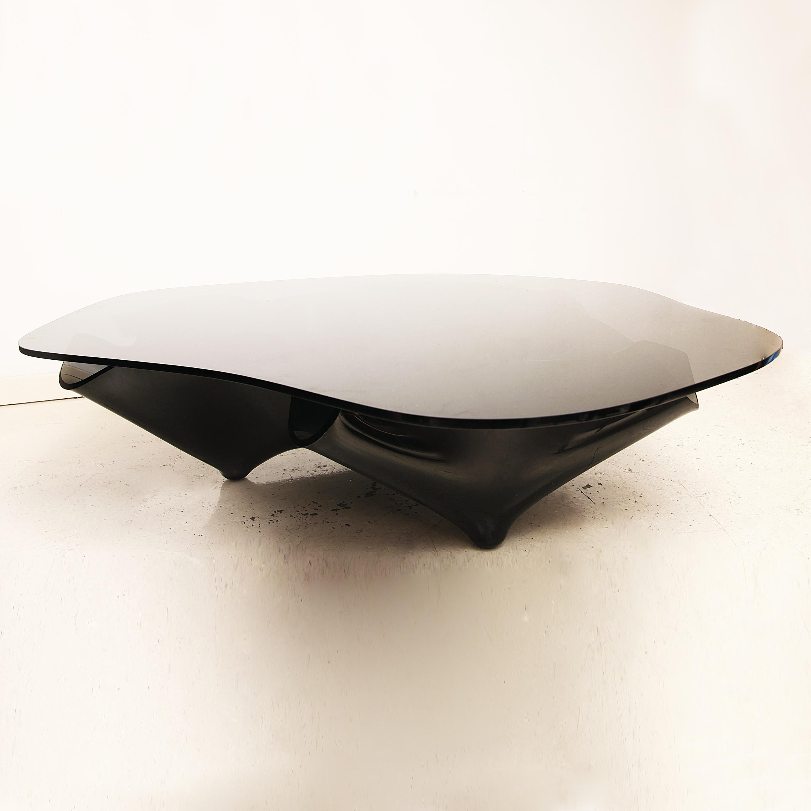 A monumental and rare black glass coffee table with handkerchief shape base and irregular glass top. Imported from USA to London for an estate in Hyde Park. This piece was produced prior to 1992 when Laurel owned Lumen Essence, Inc (L.E.I.) and she