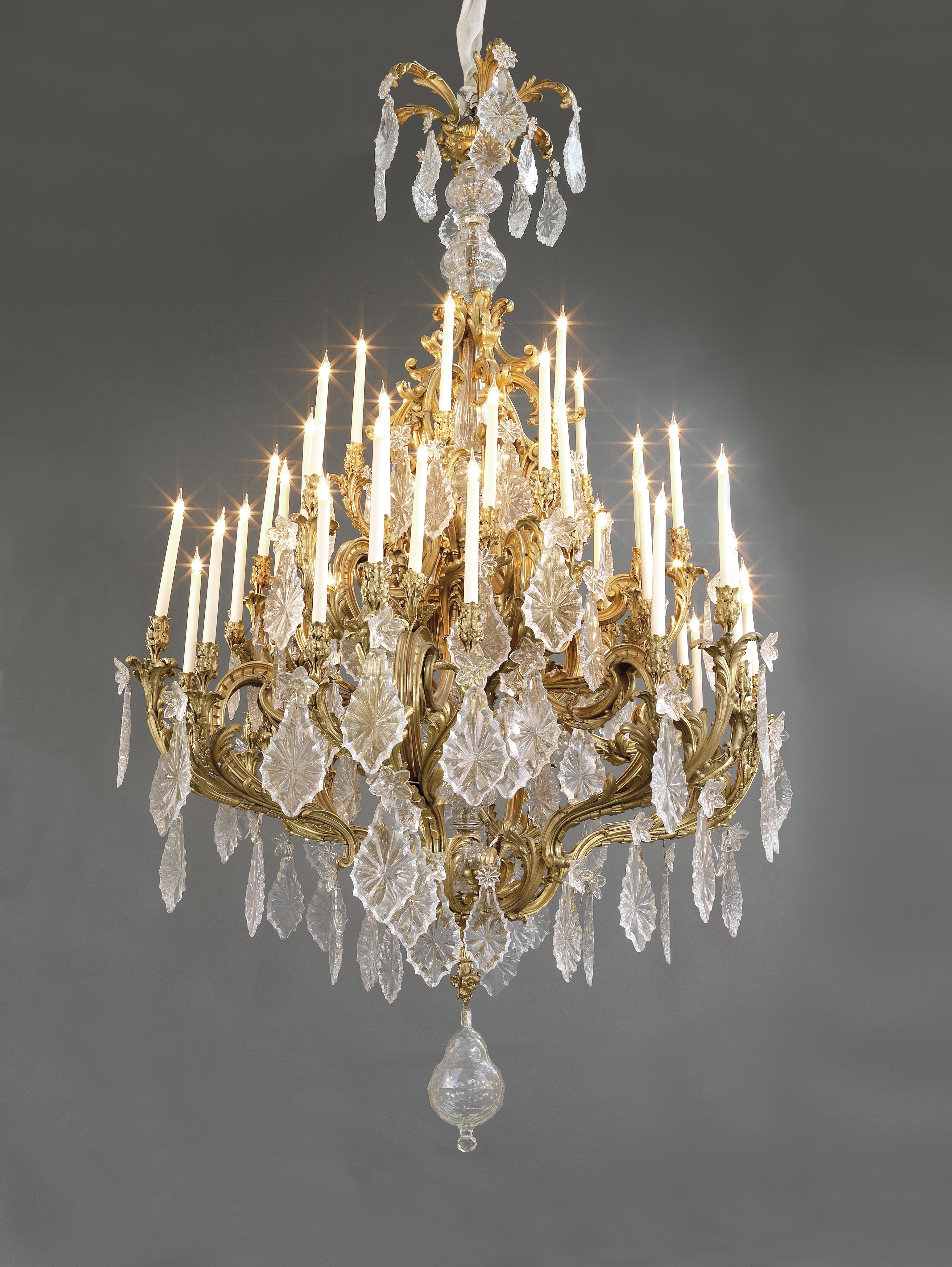 A monumental Louis XV Style gilt bronze and cut-glass forty-eight light chandelier. 

French, circa 1885.

The frame is variously stamped with numbers and 'JL'. 

This rare and exceptional chandelier has a central cut-glass baluster stem,