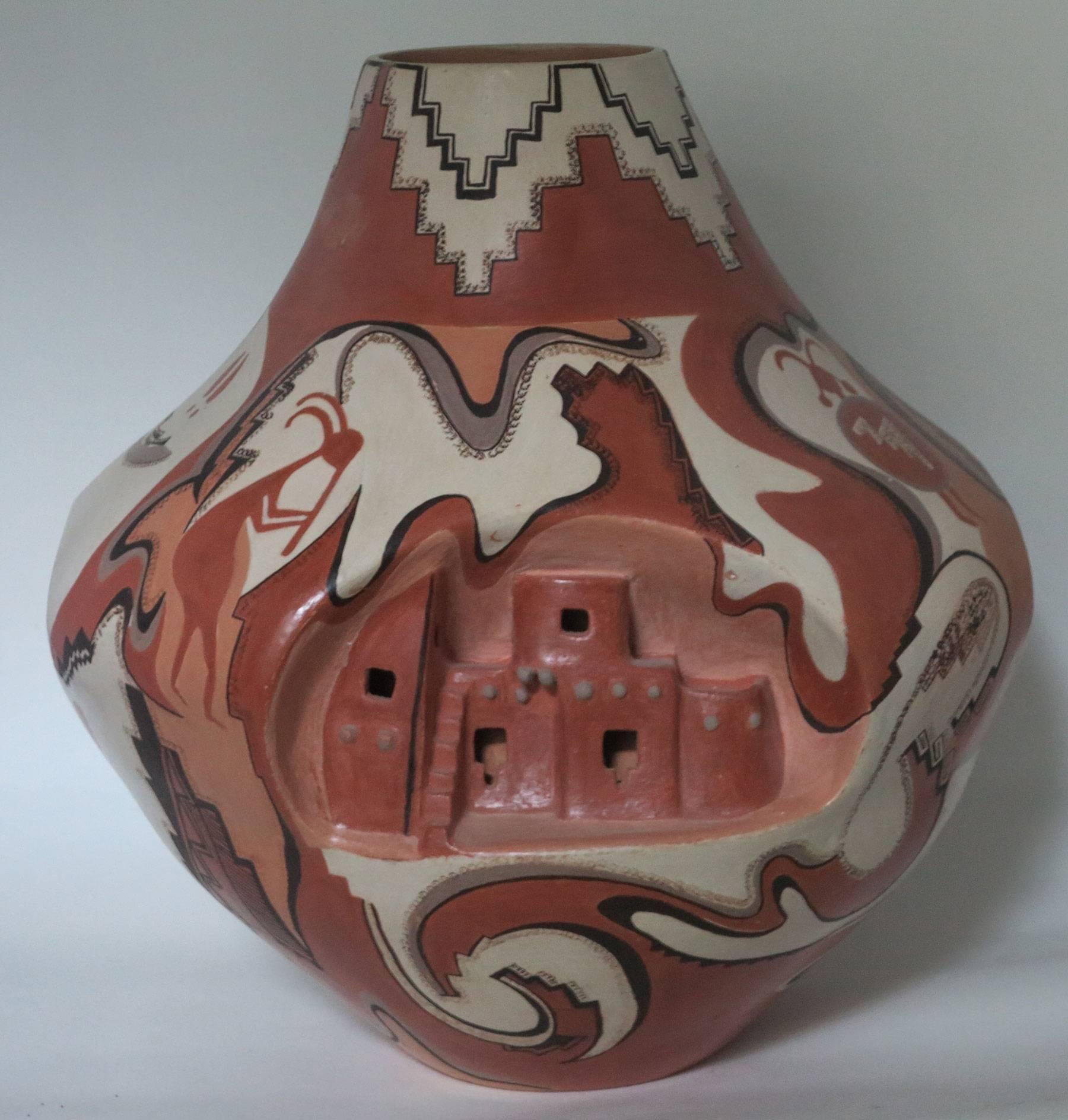 Large and important pottery vase by Native American Artist Lucy Leuppe McKelvey. Beautifully executed depicting traditional cliff dwellings and other ancient symbols of the Native American tribes. Measures: Approximate 13 inches high with a 14 inch